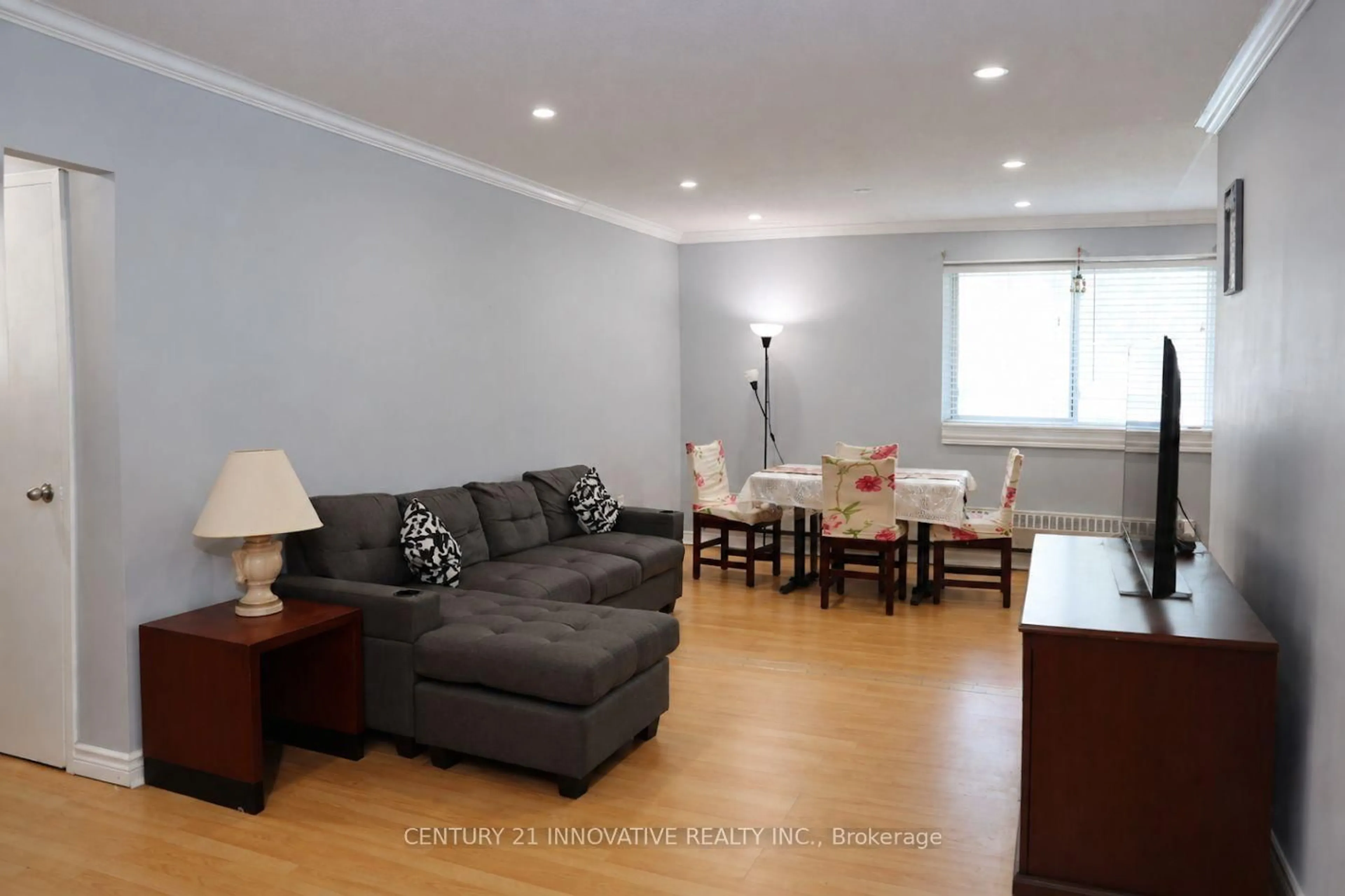 Living room with furniture, wood/laminate floor for 936 Glen St #101, Oshawa Ontario L1J 5Z7