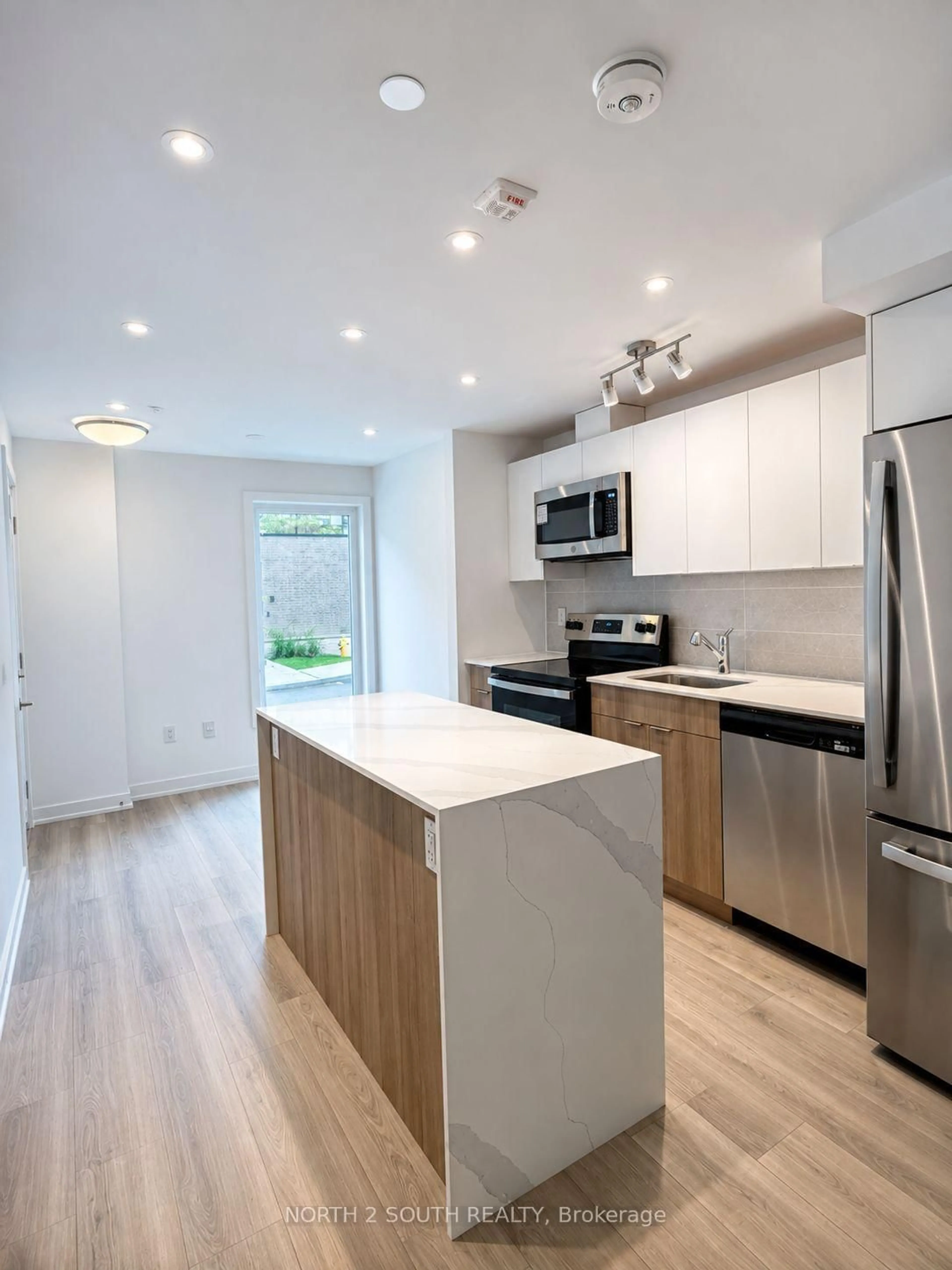 Open concept kitchen, wood/laminate floor for 10 Calamint Lane #63, Toronto Ontario M1W 2H1
