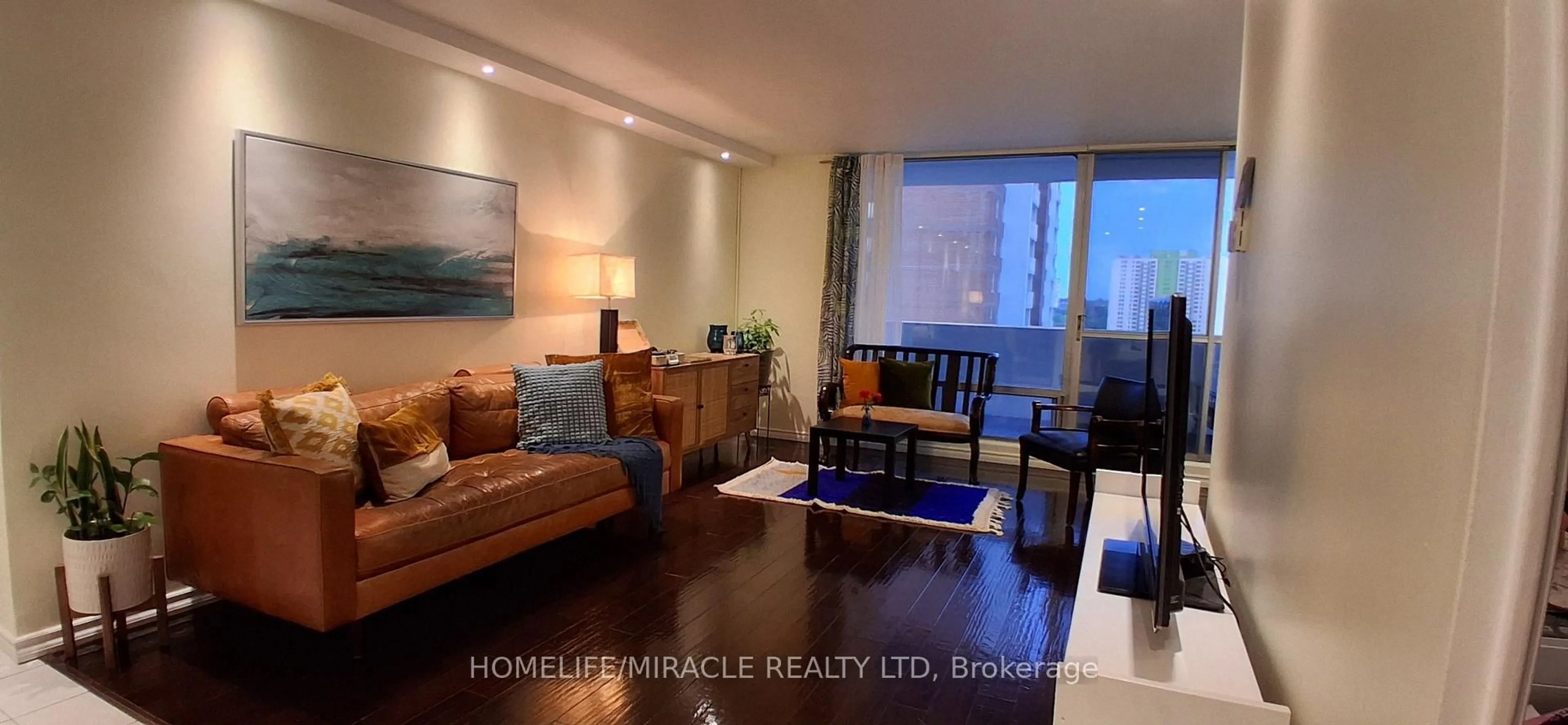 Living room with furniture, wood/laminate floor for 1 Massey Sq #1618, Toronto Ontario M4C 5L4