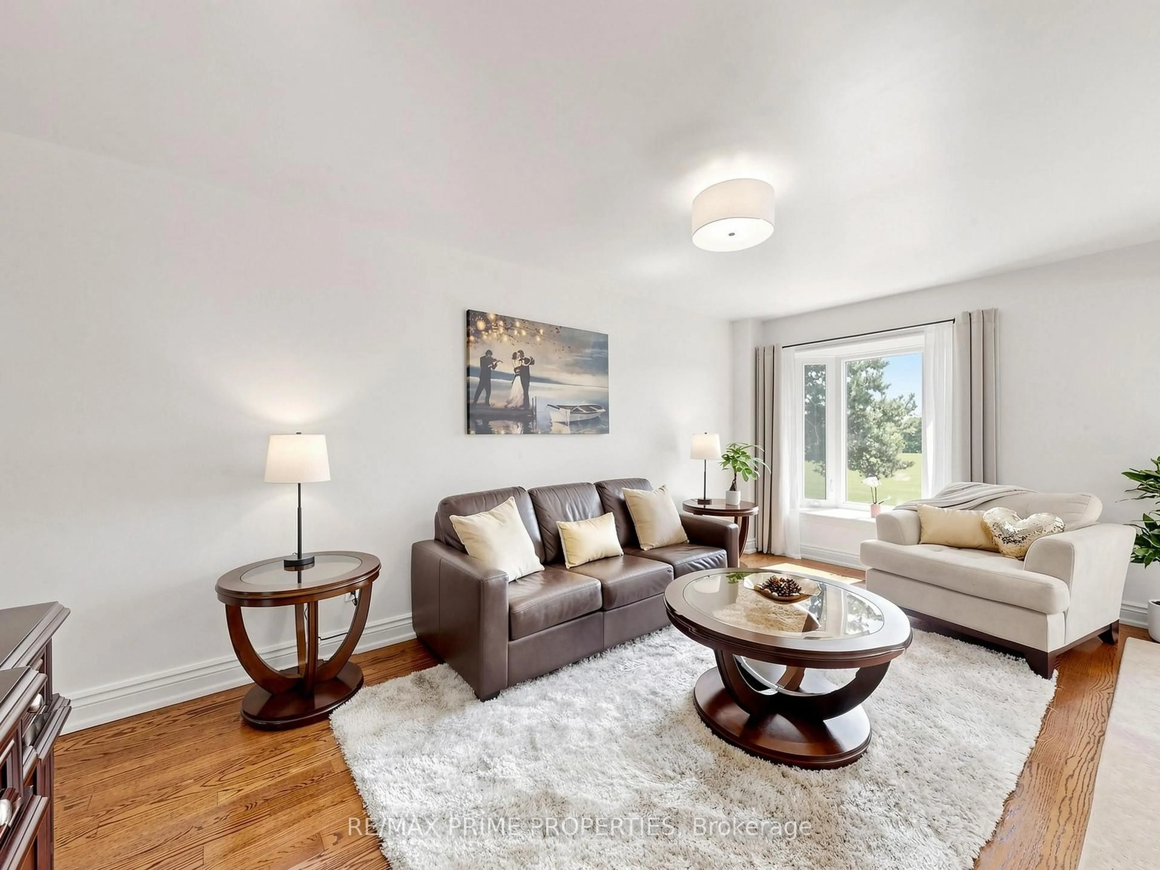 Living room with furniture, wood/laminate floor for 19 Post Horn Grve, Toronto Ontario M1S 3N3