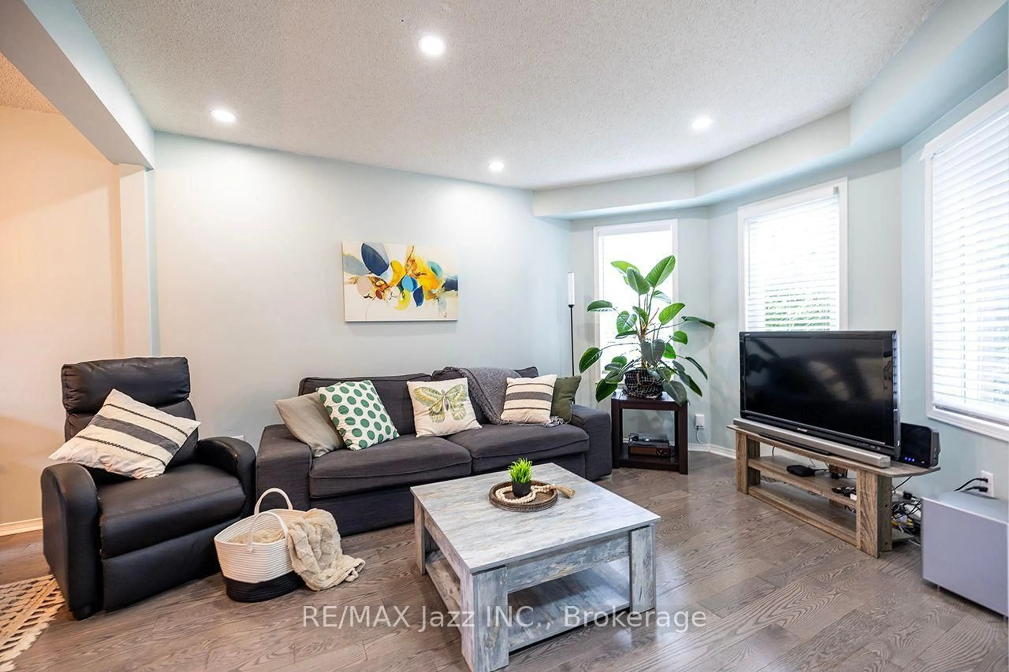 Living room with furniture, wood/laminate floor for 23 Meredith Crt, Clarington Ontario L1E 2V9