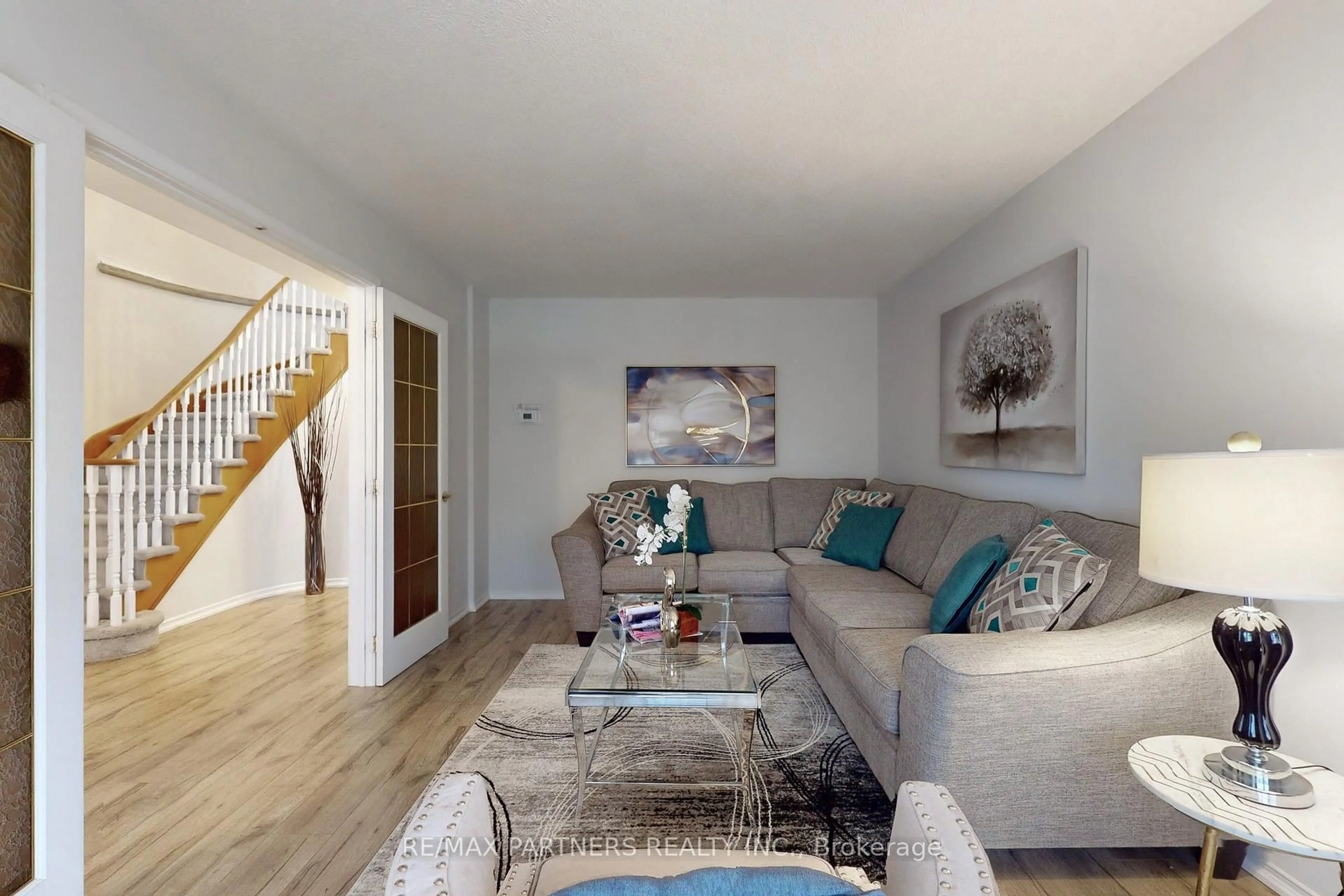 Living room with furniture, wood/laminate floor for 15 Ribblesdale Dr, Whitby Ontario L1N 6Z3