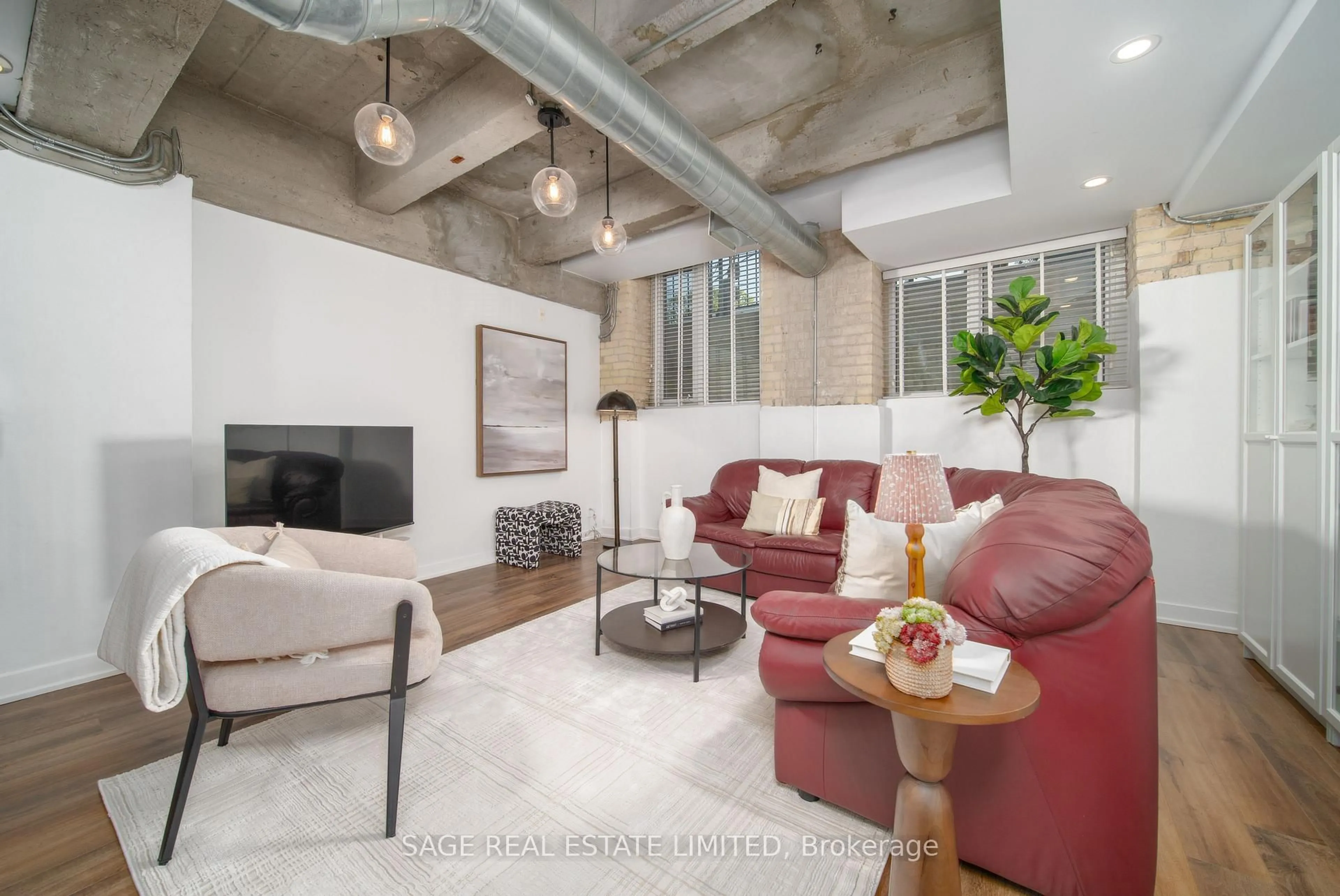 Living room with furniture, cement floor for 201 Carlaw Ave #128, Toronto Ontario M4M 2S3