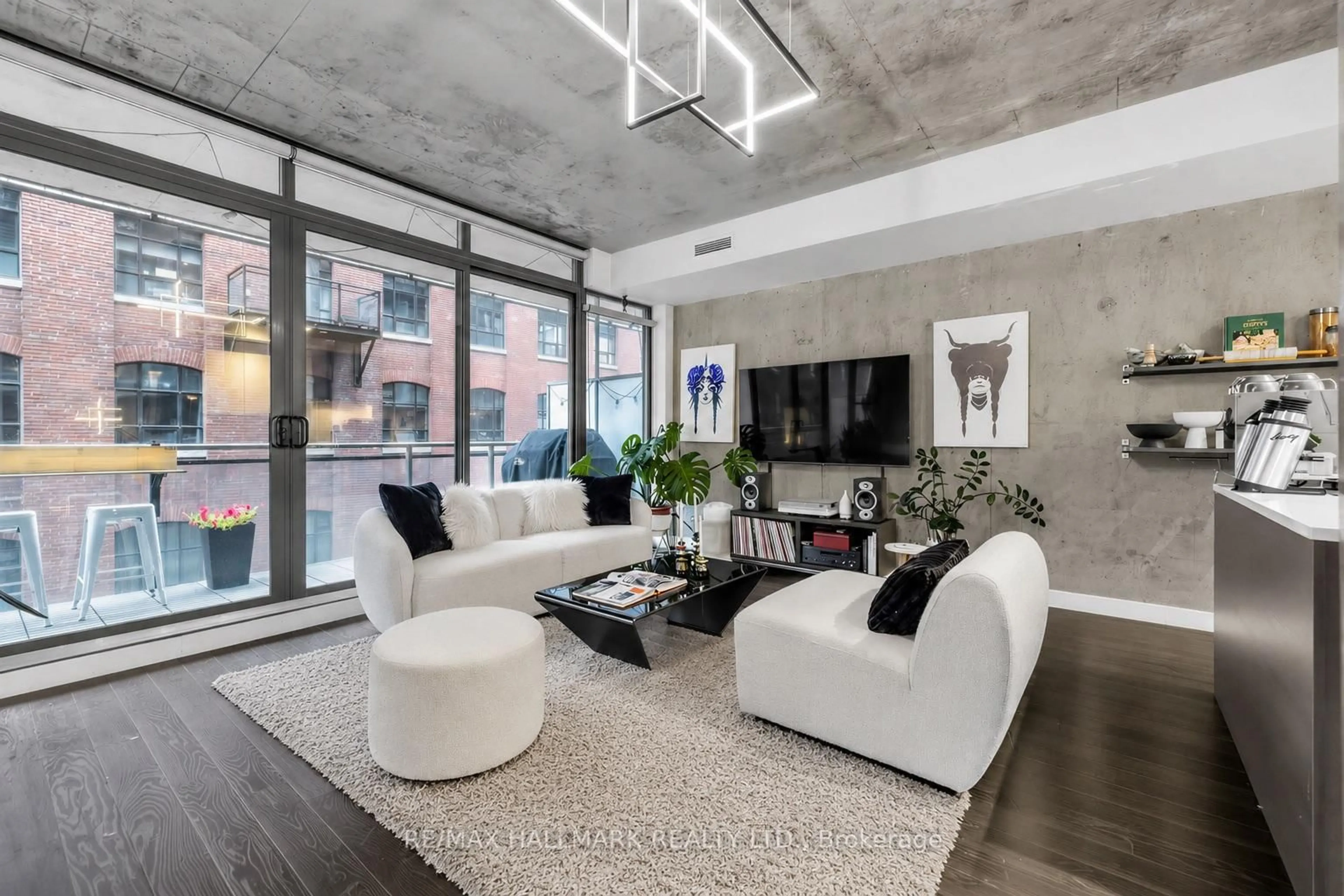 Living room with furniture, cement floor for 90 Broadview Ave #408, Toronto Ontario M4M 0A7