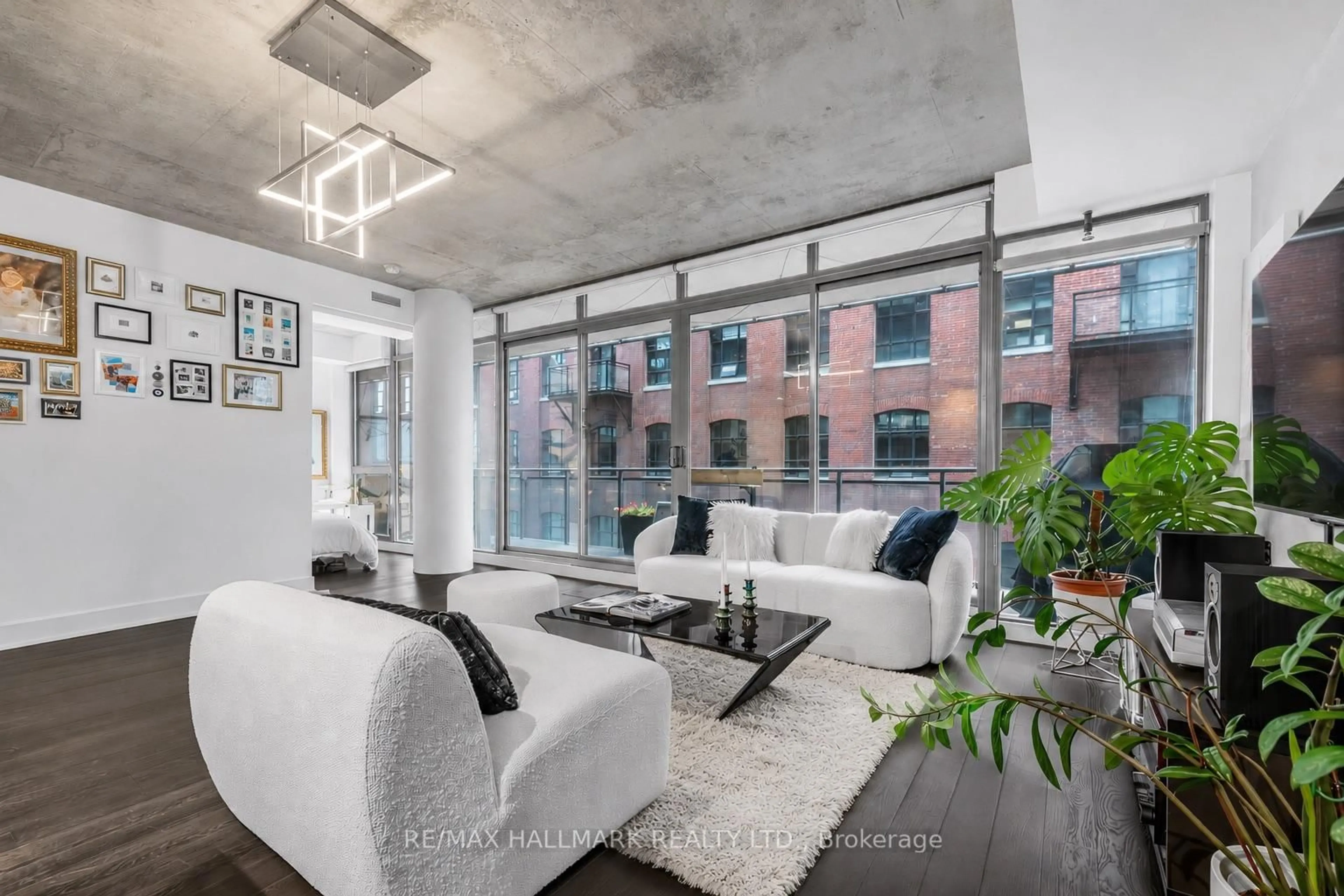 Living room with furniture, cement floor for 90 Broadview Ave #408, Toronto Ontario M4M 0A7
