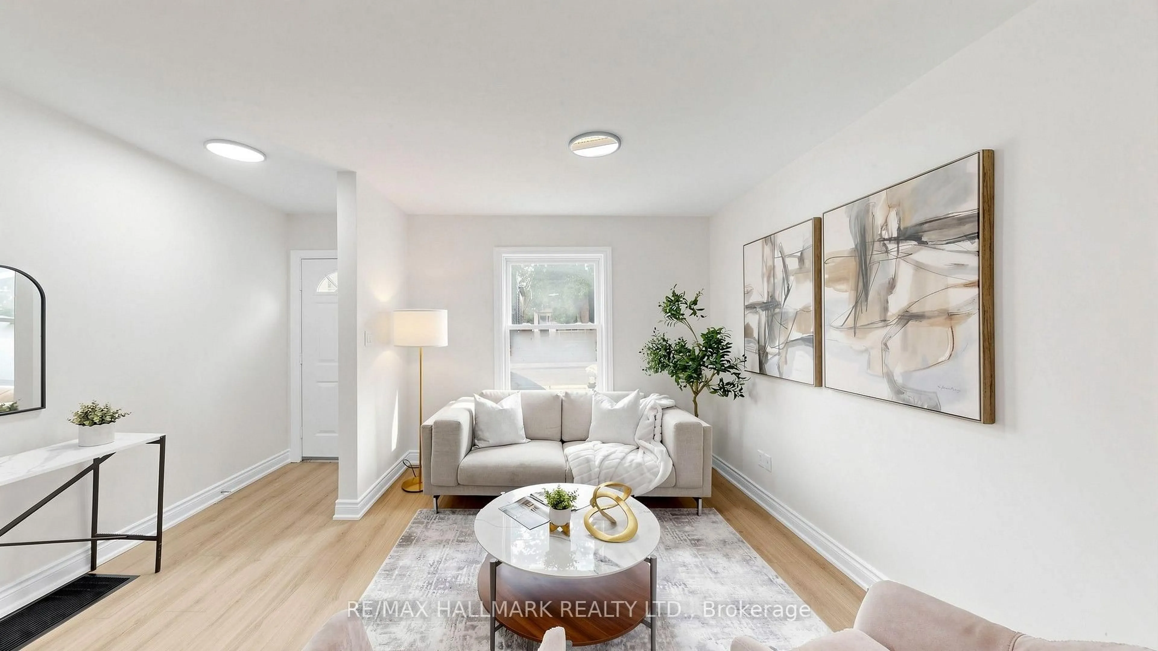 Living room with furniture, wood/laminate floor for 16 Queensdale Ave, Toronto Ontario M4J 1X9