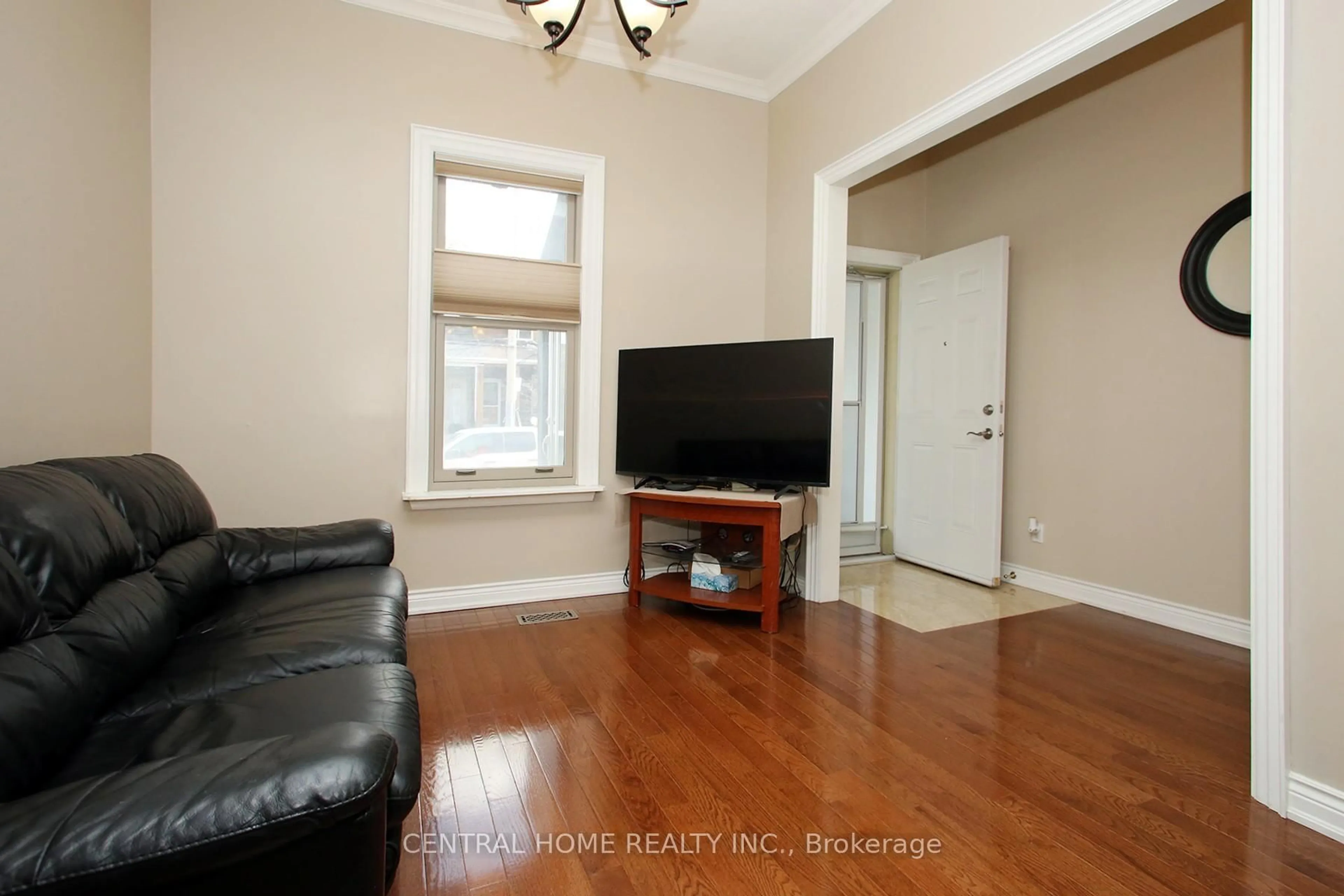 Living room with furniture, wood/laminate floor for 106 Carlaw Ave, Toronto Ontario M4M 2R7