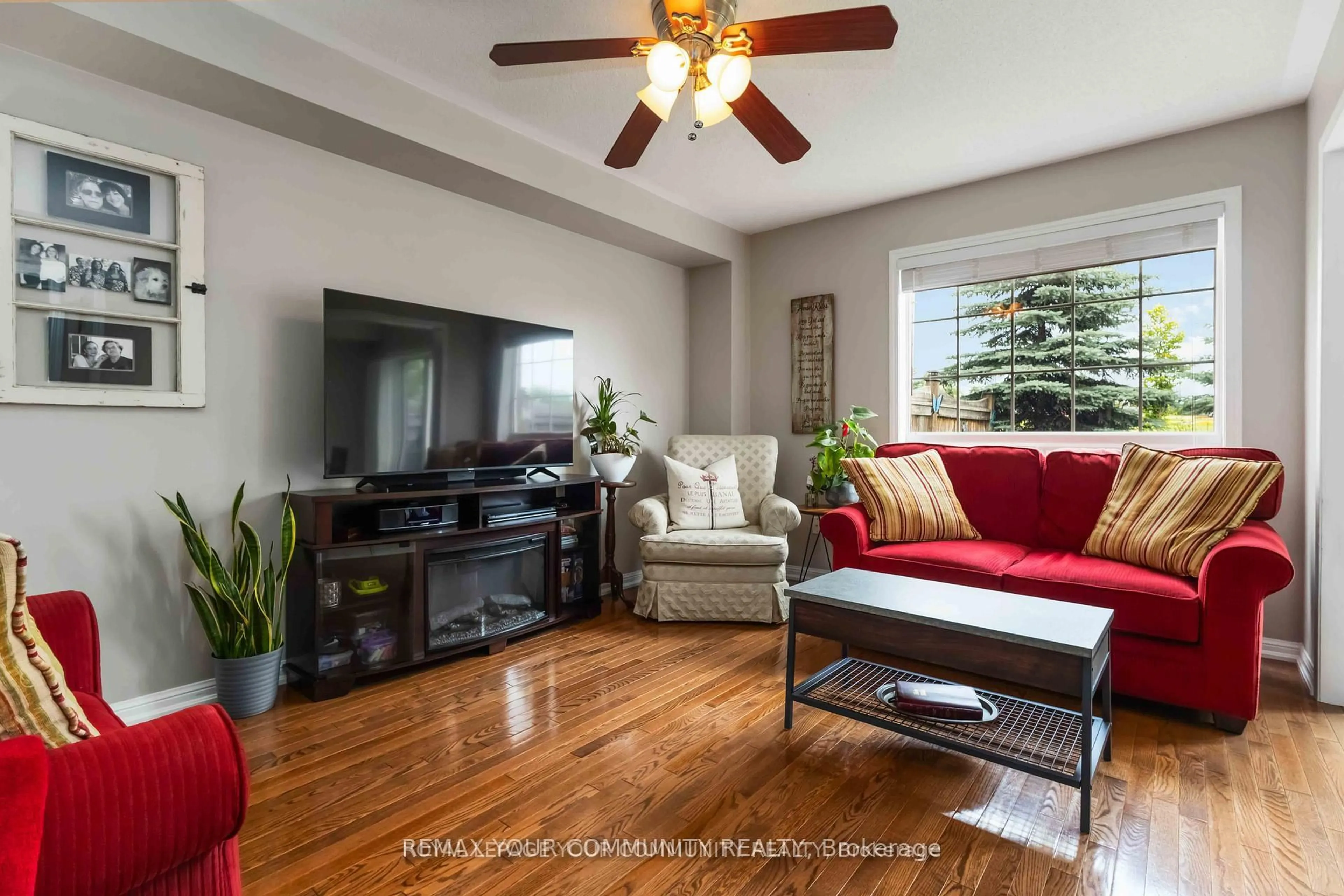 Living room with furniture, wood/laminate floor for 49 Latchford Way, Whitby Ontario L1N 9R3