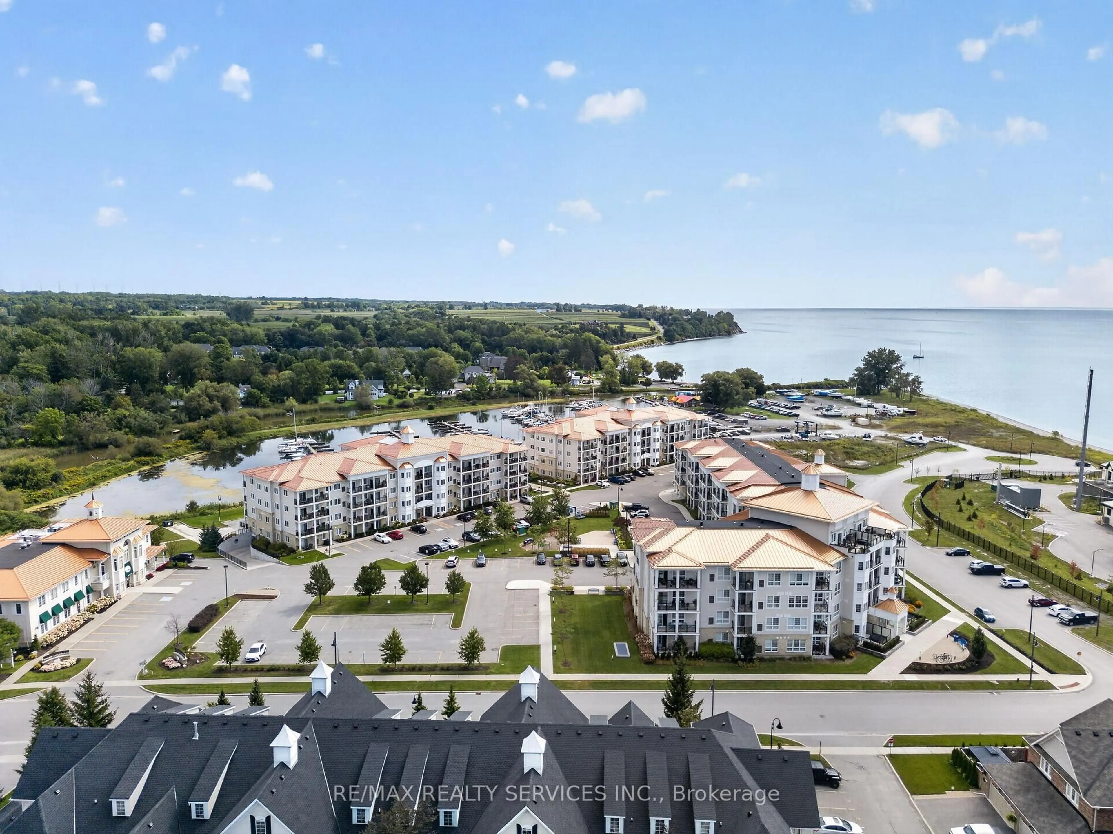 A pic from outside/outdoor area/front of a property/back of a property/a pic from drone, water/lake/river/ocean view for 50 Lakebreeze Dr #129, Clarington Ontario L1B 0V9