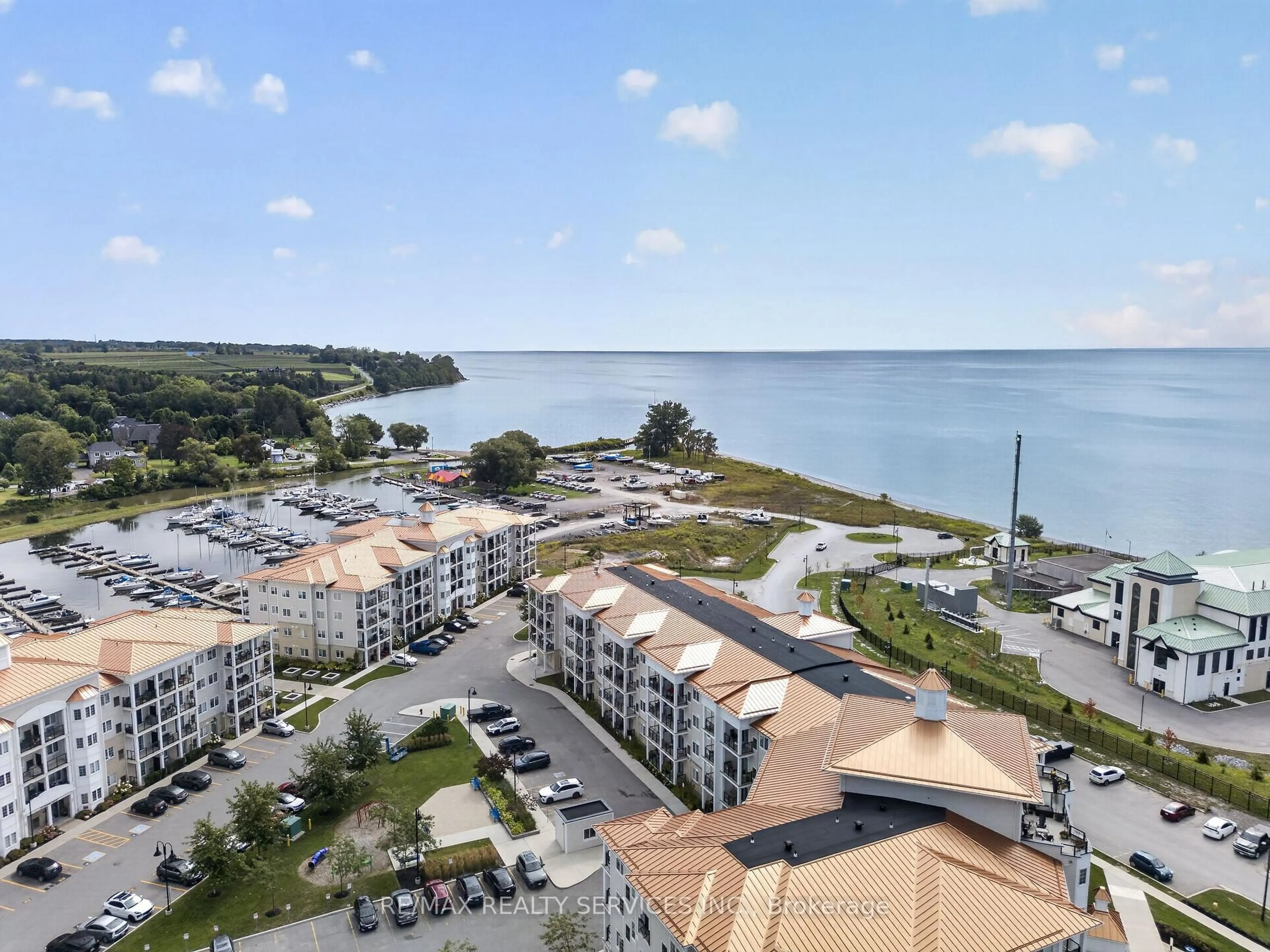 A pic from outside/outdoor area/front of a property/back of a property/a pic from drone, water/lake/river/ocean view for 50 Lakebreeze Dr #129, Clarington Ontario L1B 0V9