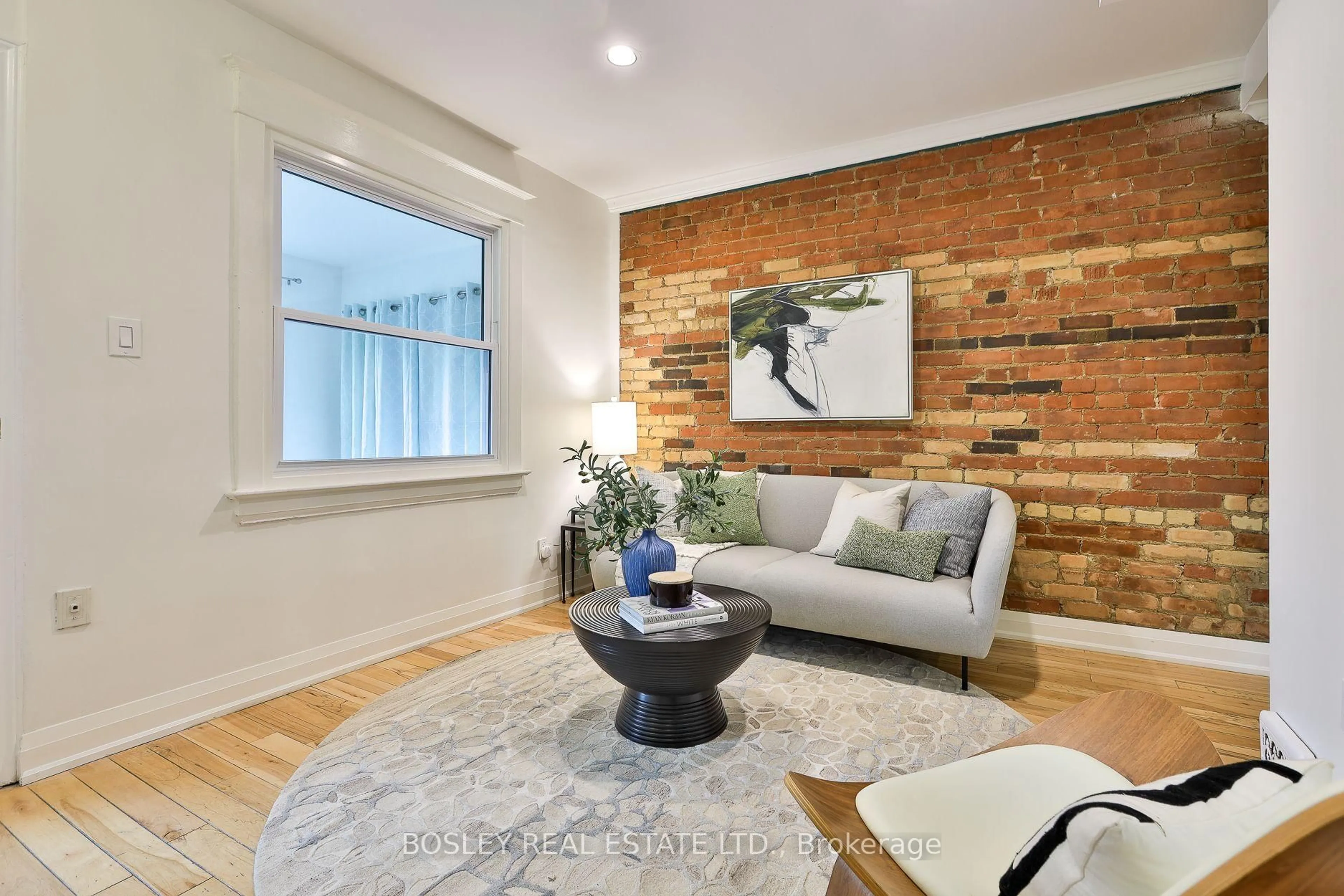 Living room with furniture, wood/laminate floor for 32 Mountalan Ave, Toronto Ontario M4J 1H4