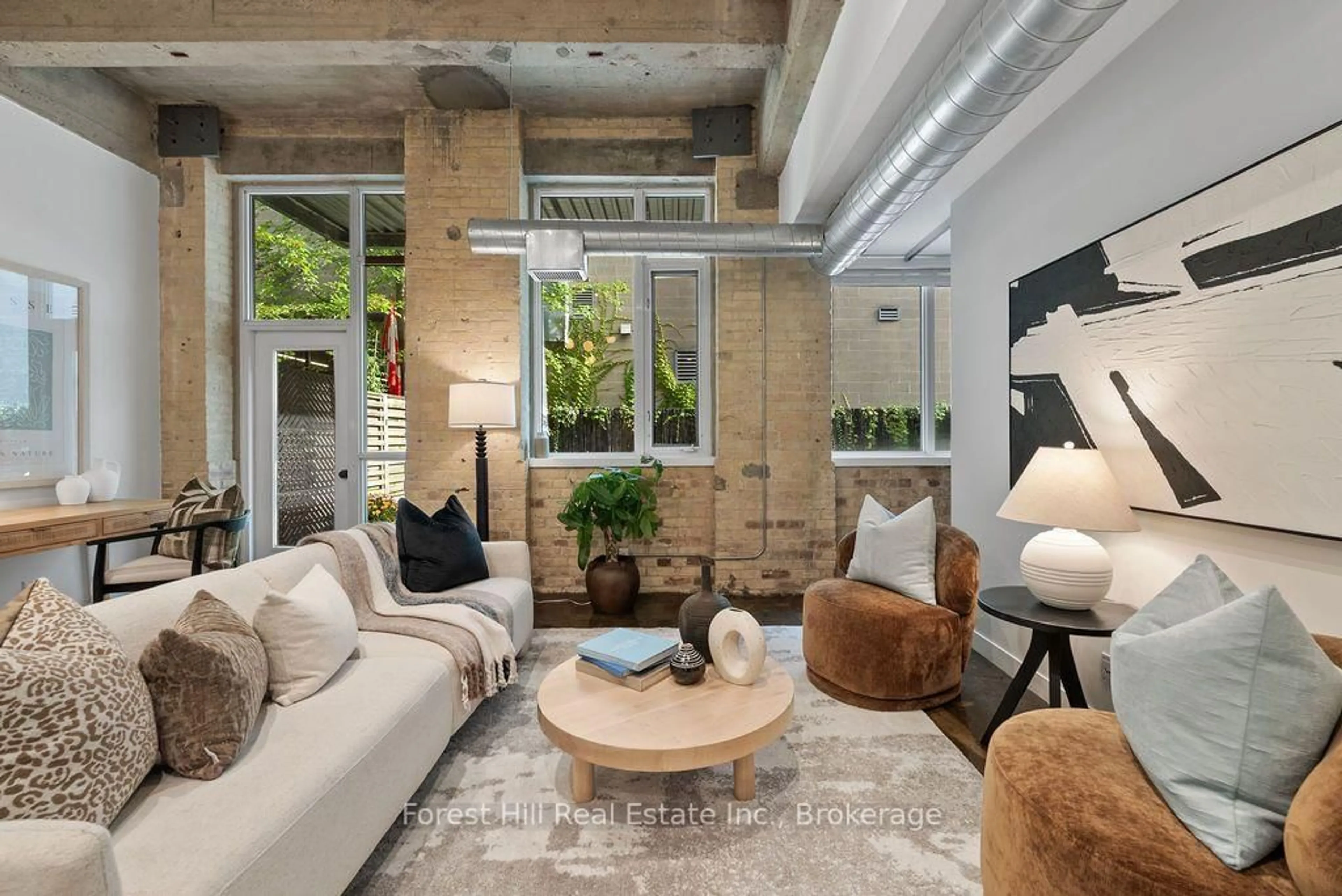 Living room with furniture, cement floor for 201 Carlaw Ave #119, Toronto Ontario M4M 2S3