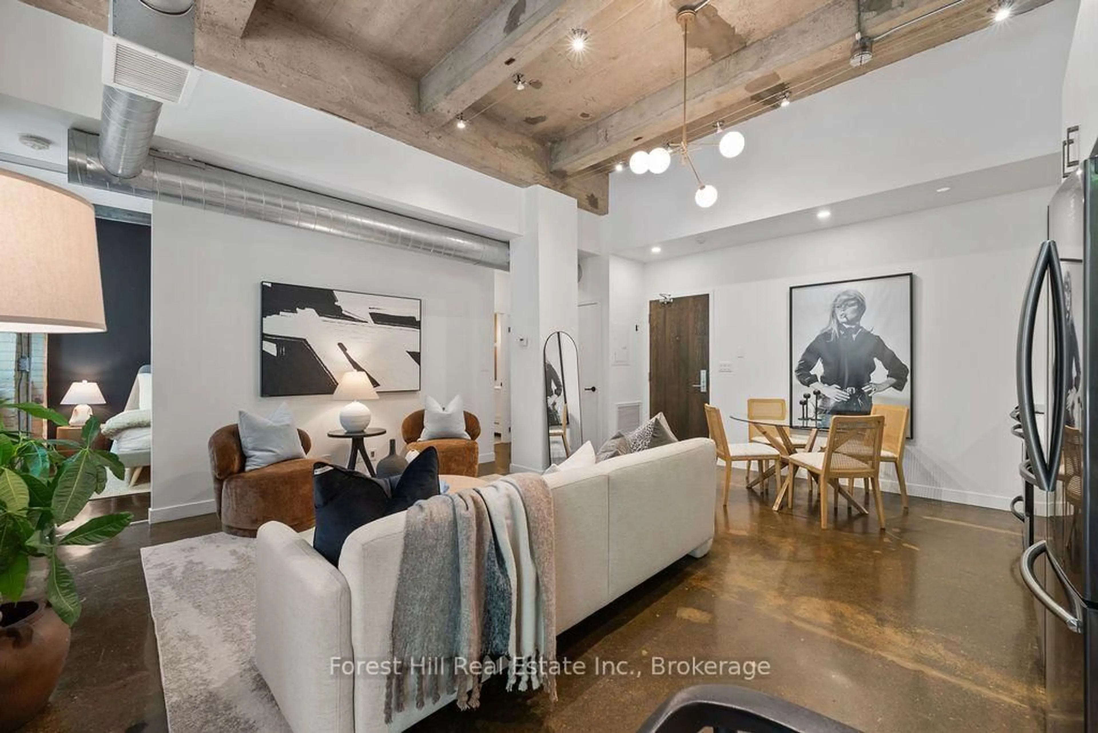Living room with furniture, cement floor for 201 Carlaw Ave #119, Toronto Ontario M4M 2S3