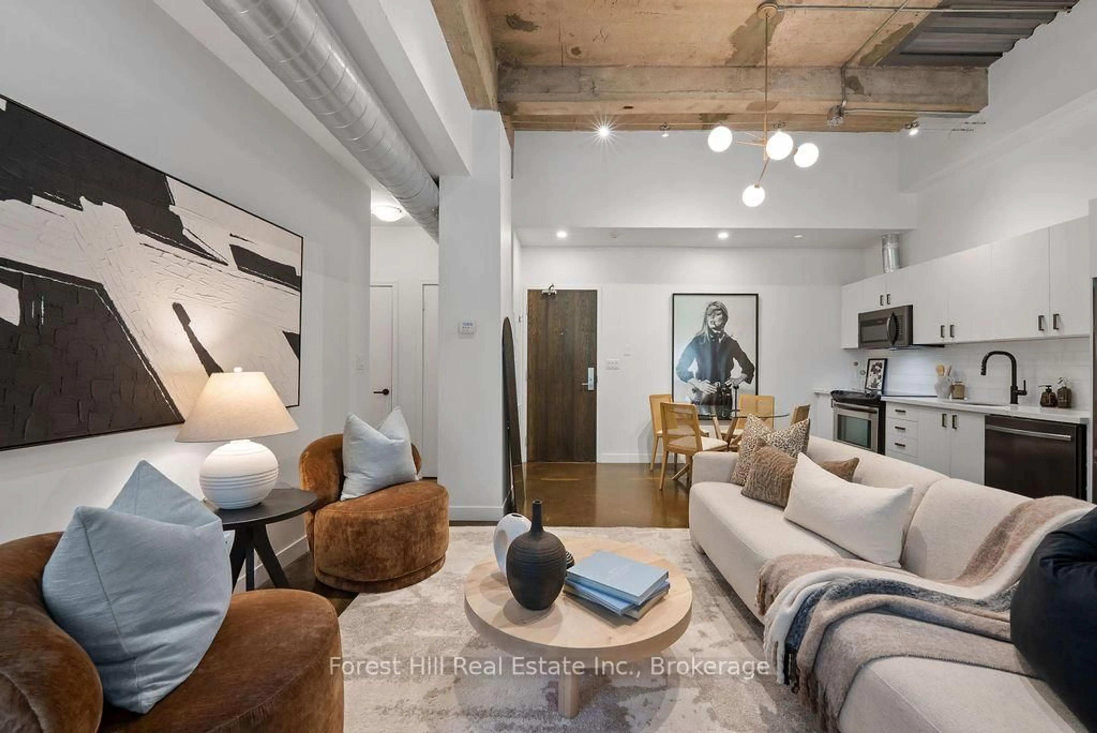 Living room with furniture, cement floor for 201 Carlaw Ave #119, Toronto Ontario M4M 2S3