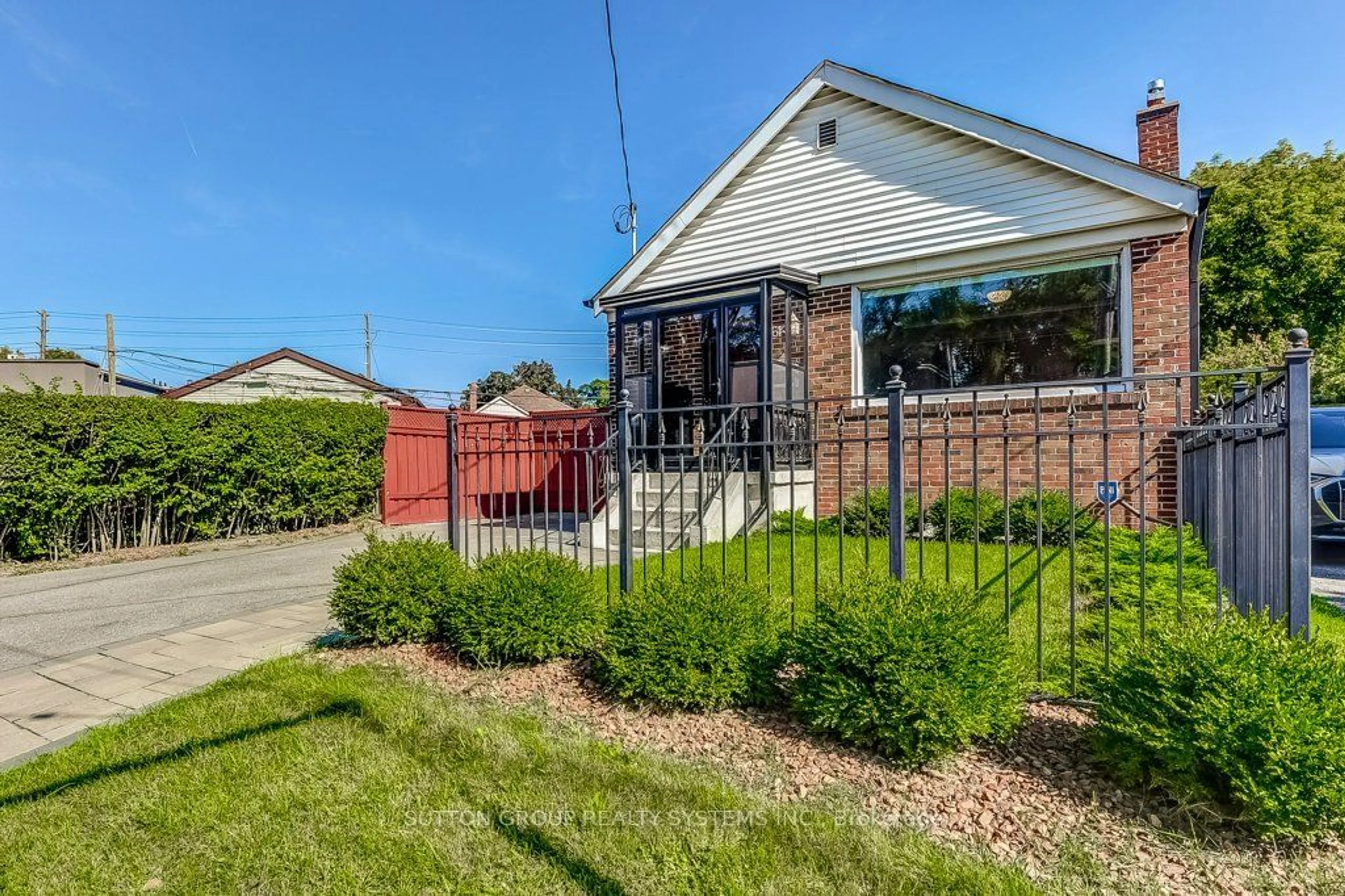 Frontside or backside of a home, the fenced backyard for 61 Danforth Rd, Toronto Ontario M1L 3W5