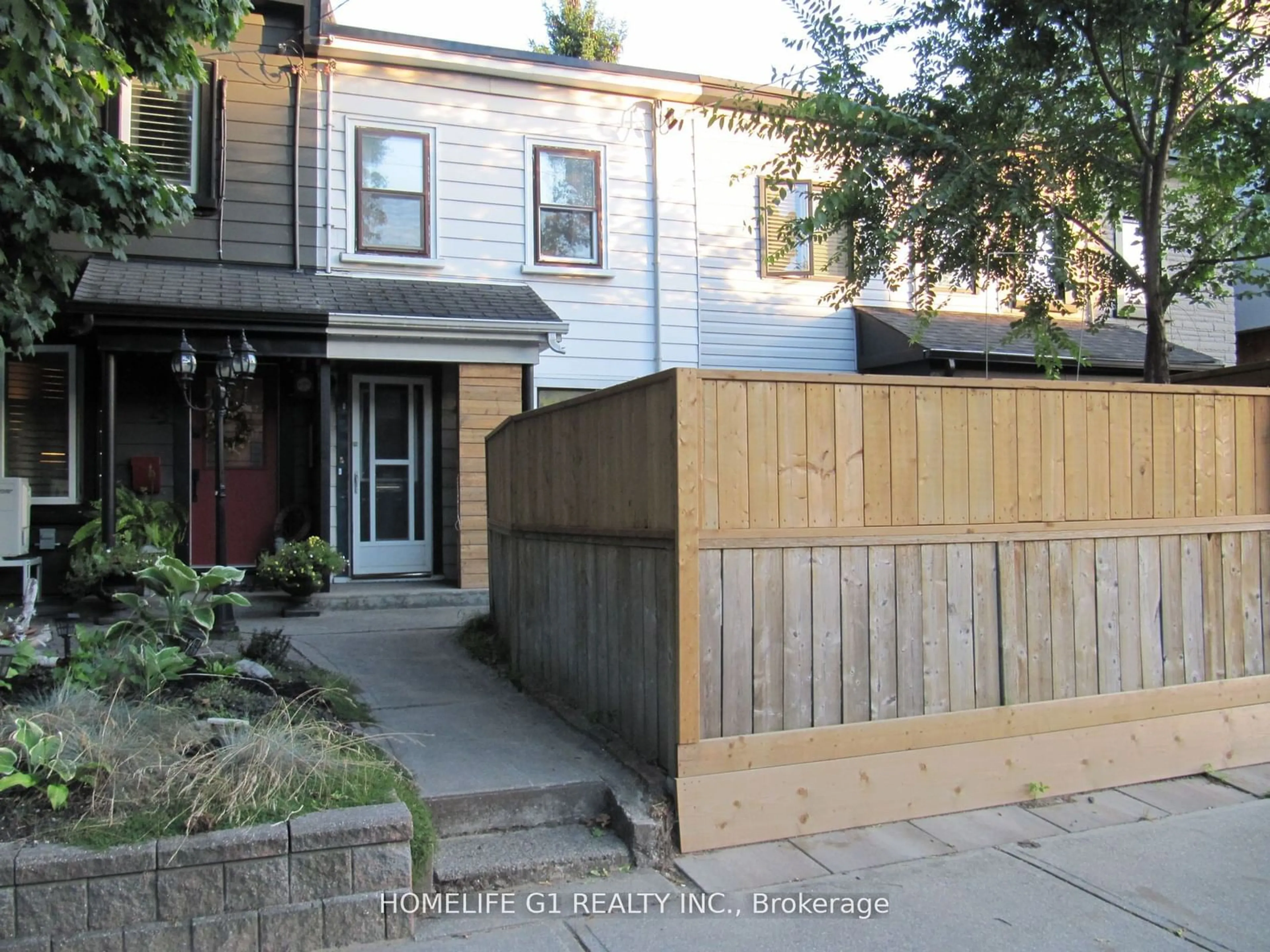 Frontside or backside of a home, the fenced backyard for 23 Myrtle Ave, Toronto Ontario M4M 2A3