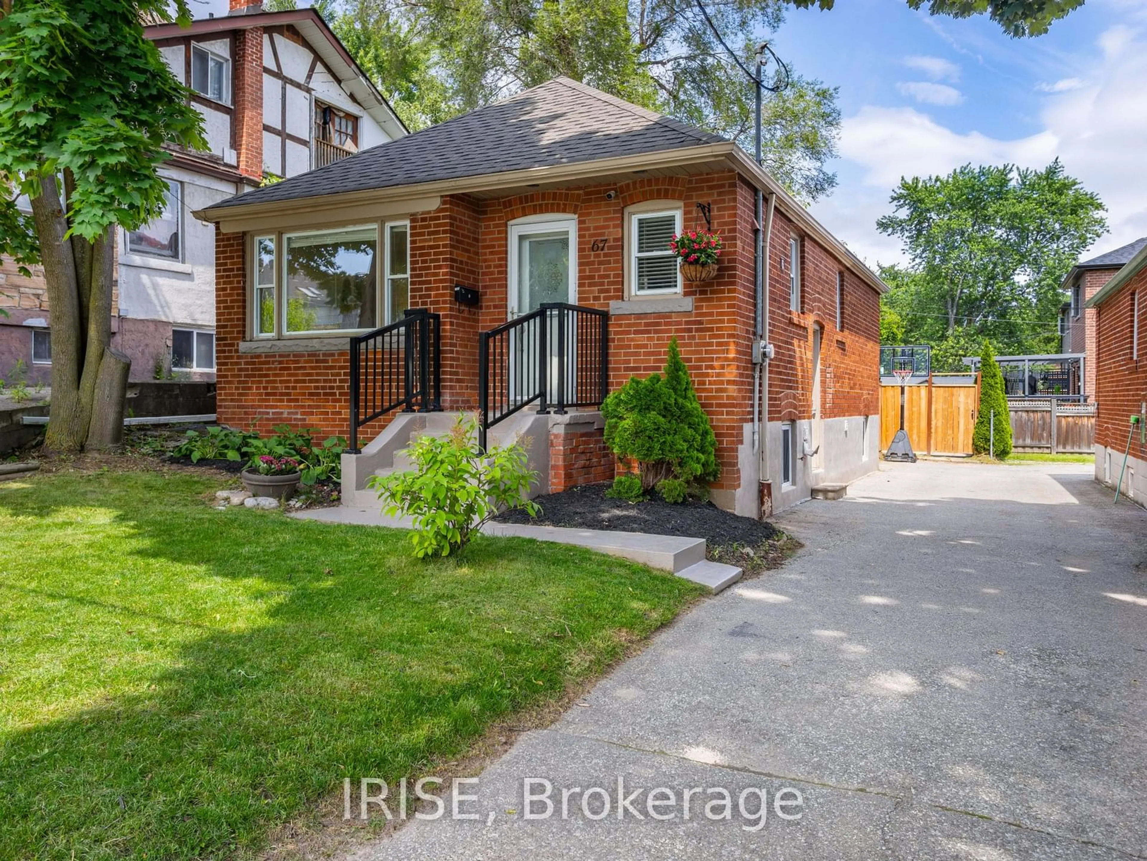 Frontside or backside of a home, the fenced backyard for 67 Glenburn Ave, Toronto Ontario M4B 2X6