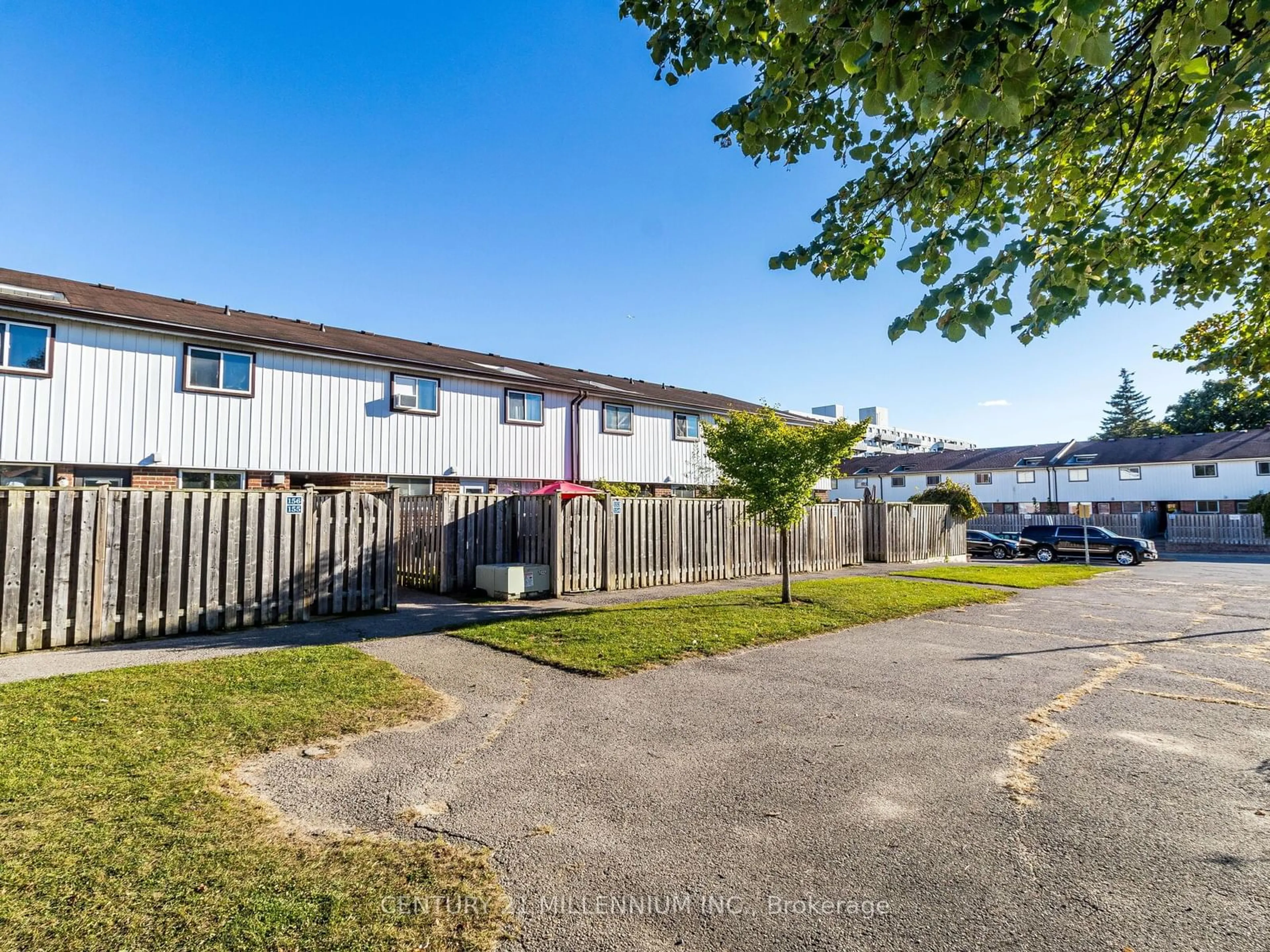 A pic from exterior of the house or condo, the fenced backyard for 120 Nonquon Rd #153, Oshawa Ontario L1G 7E6