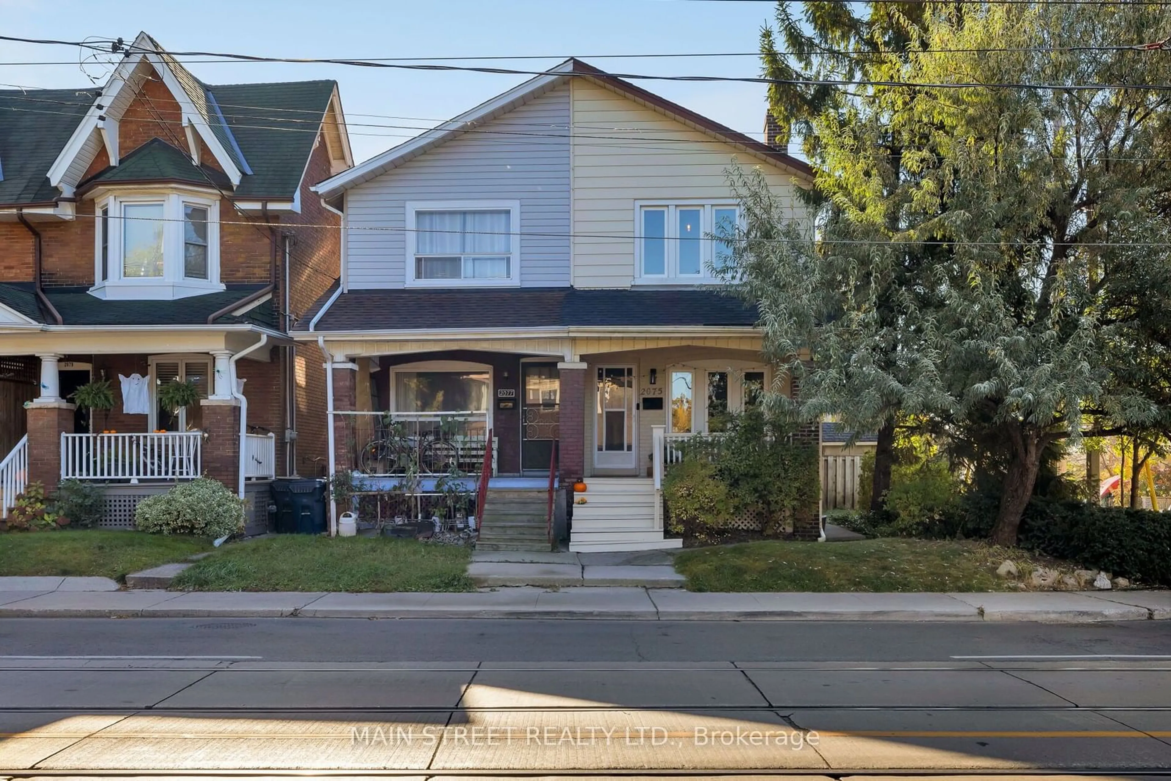 A pic from exterior of the house or condo, the street view for 2075 Gerrard St, Toronto Ontario M4E 2B6