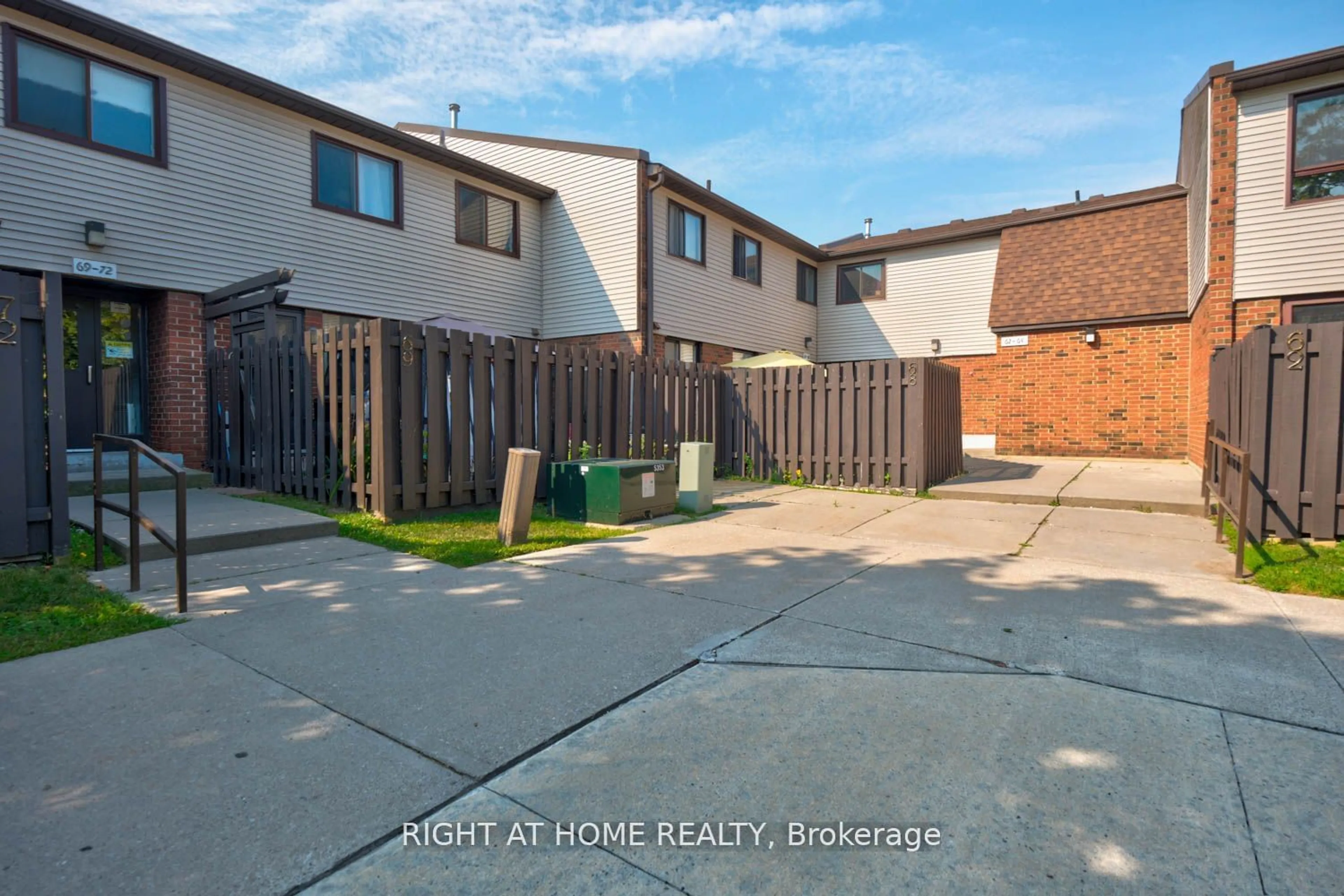 A pic from exterior of the house or condo, the fenced backyard for 960 Glen St #68, Oshawa Ontario L1J 6E8