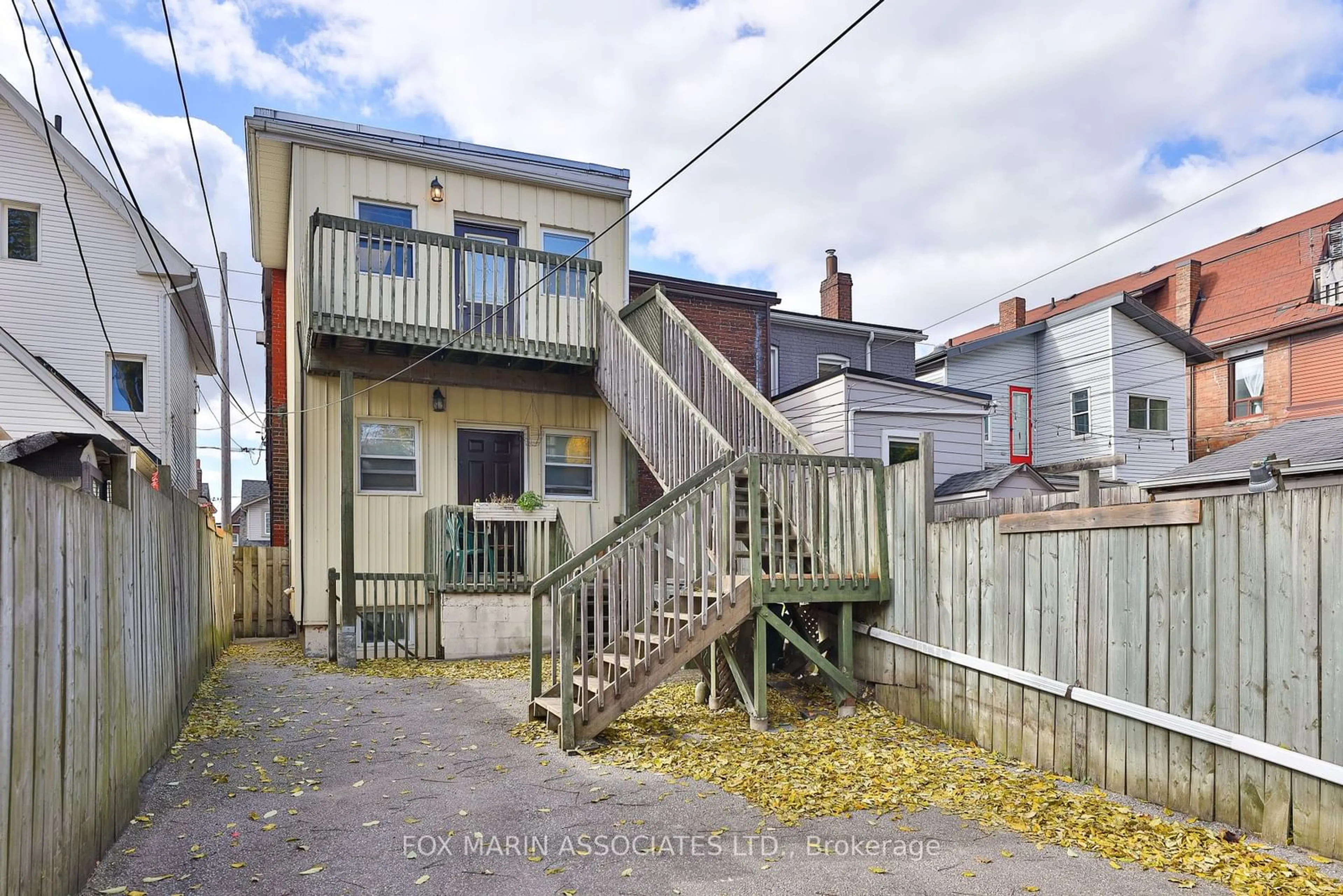 A pic from exterior of the house or condo, the fenced backyard for 335 Greenwood Ave, Toronto Ontario M4L 2R6