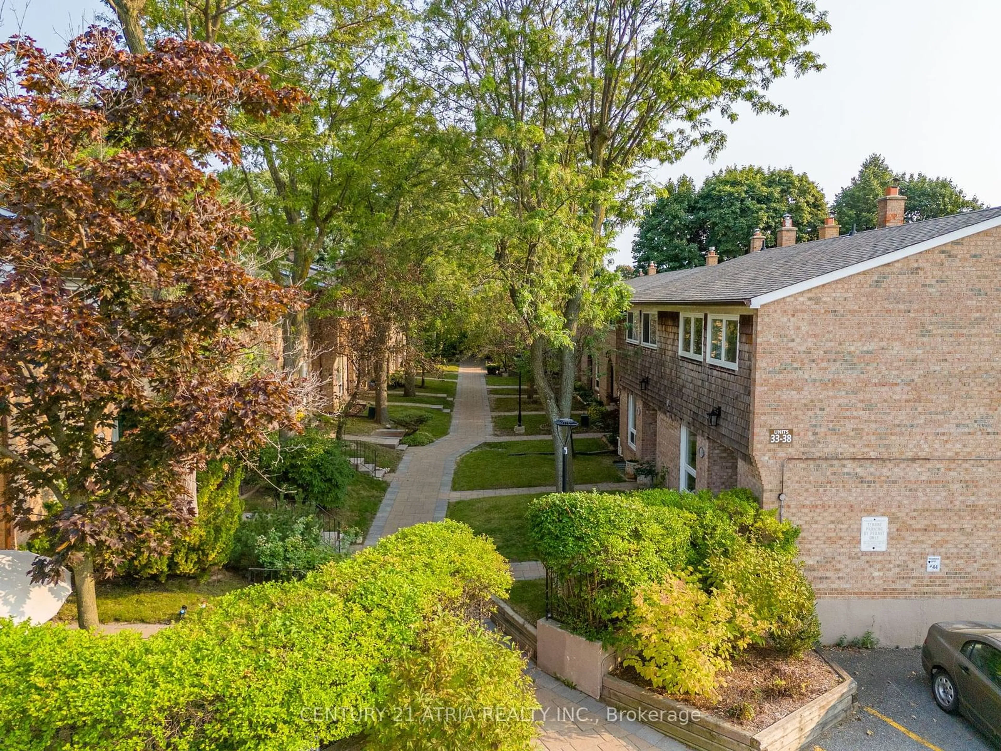 A pic from exterior of the house or condo, the fenced backyard for 1 Wootten Way #45, Markham Ontario L3P 3H7