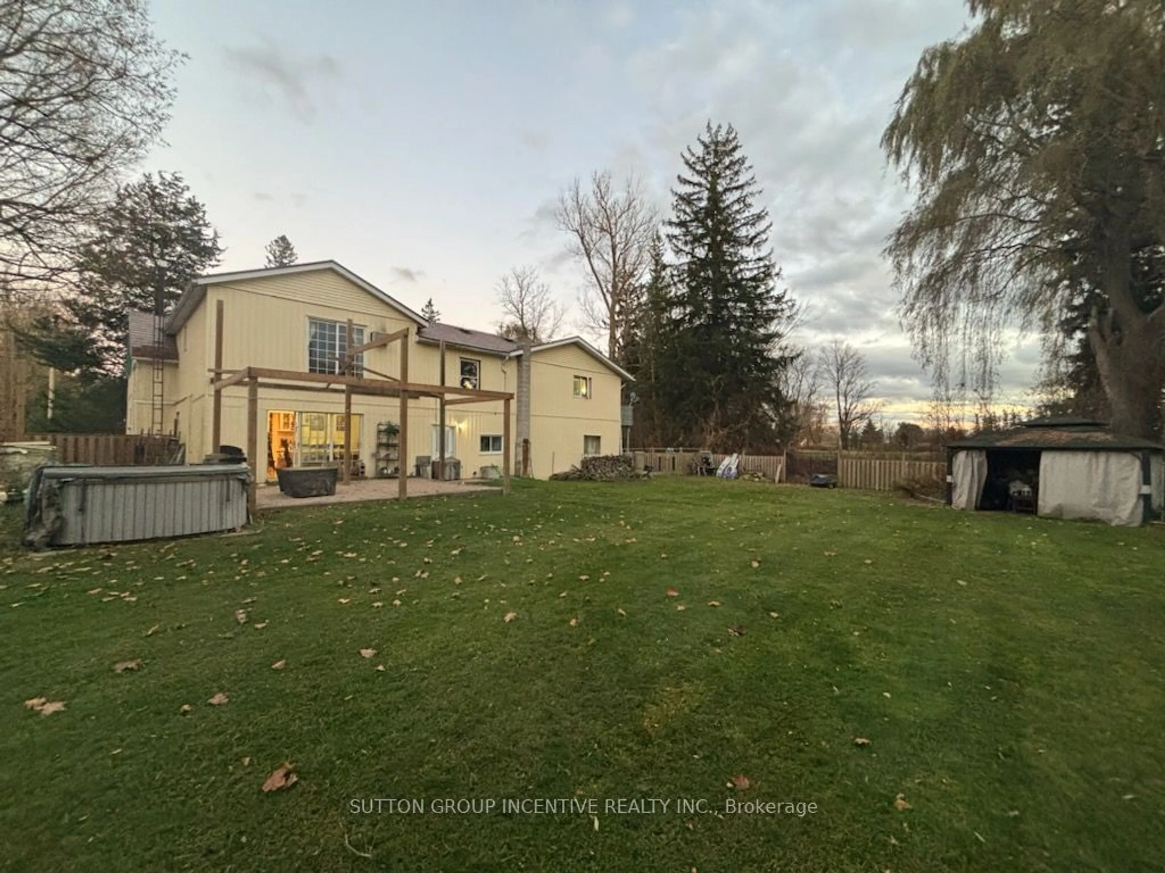 Frontside or backside of a home, the fenced backyard for 8384 Sixth Line, Essa Ontario L0M 1T0