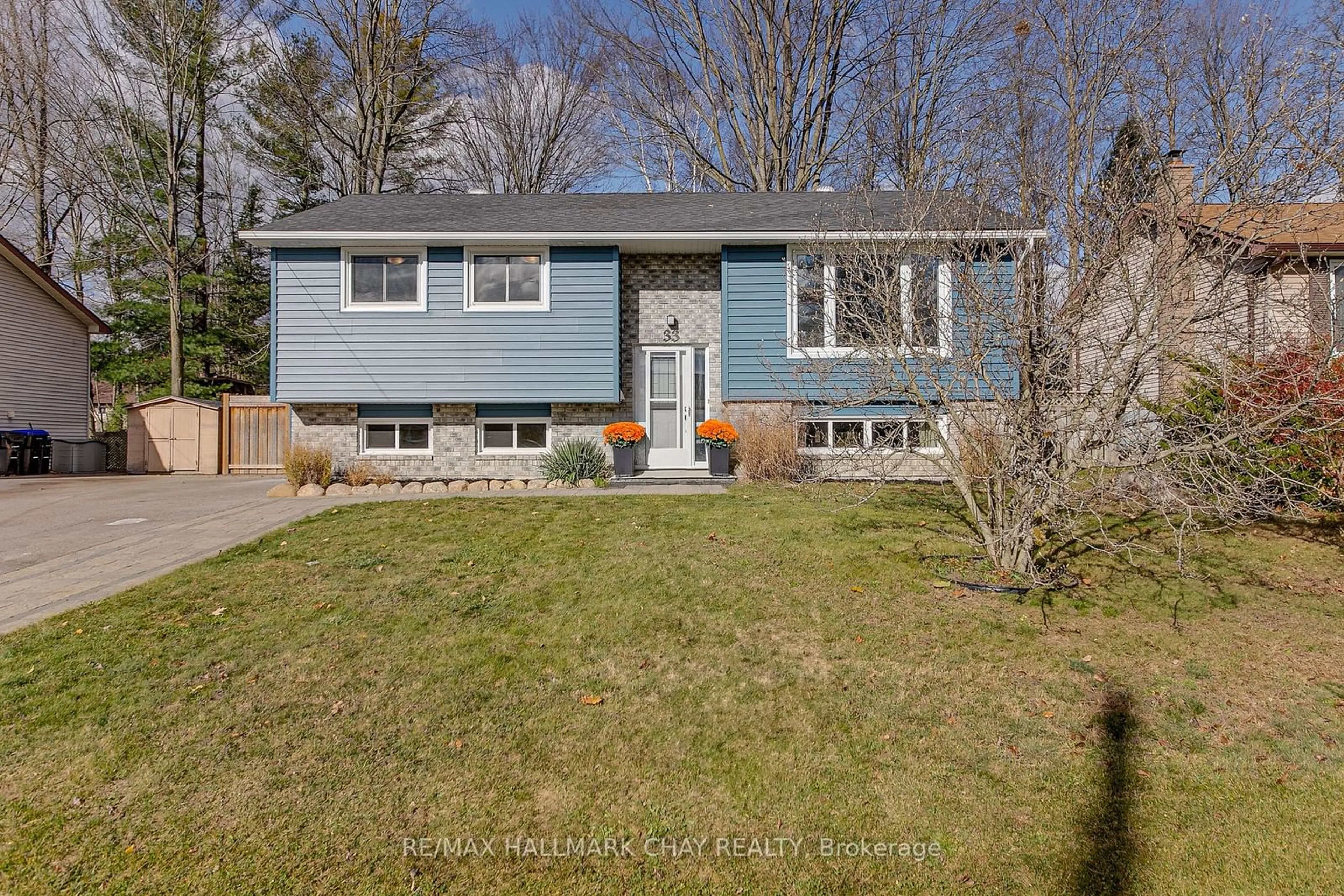 Frontside or backside of a home, the fenced backyard for 33 Tree Top St, Essa Ontario L0M 1B2