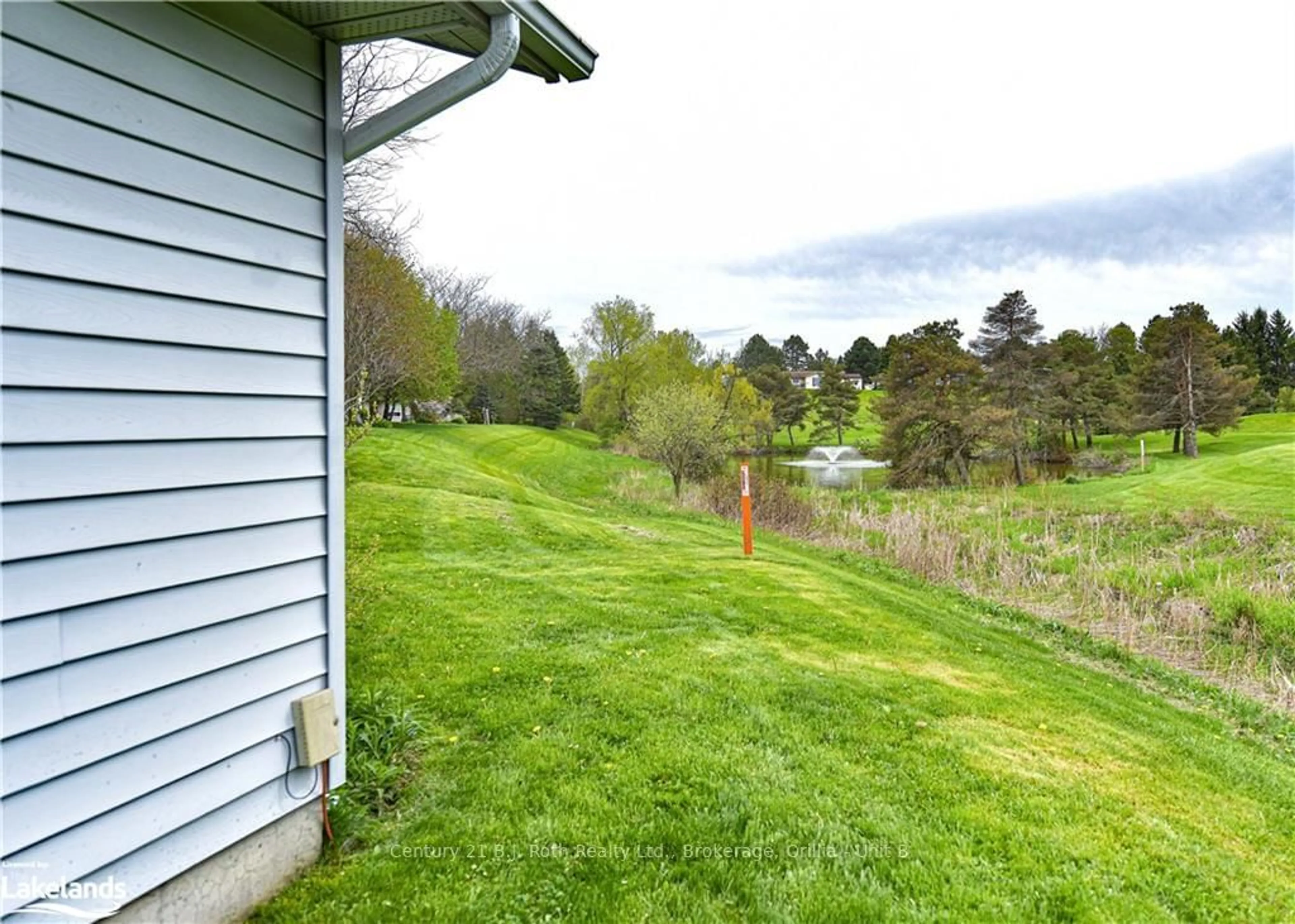 A pic from exterior of the house or condo, the fenced backyard for 56 TECUMSETH PINES Dr, New Tecumseth Ontario L0G 1W0