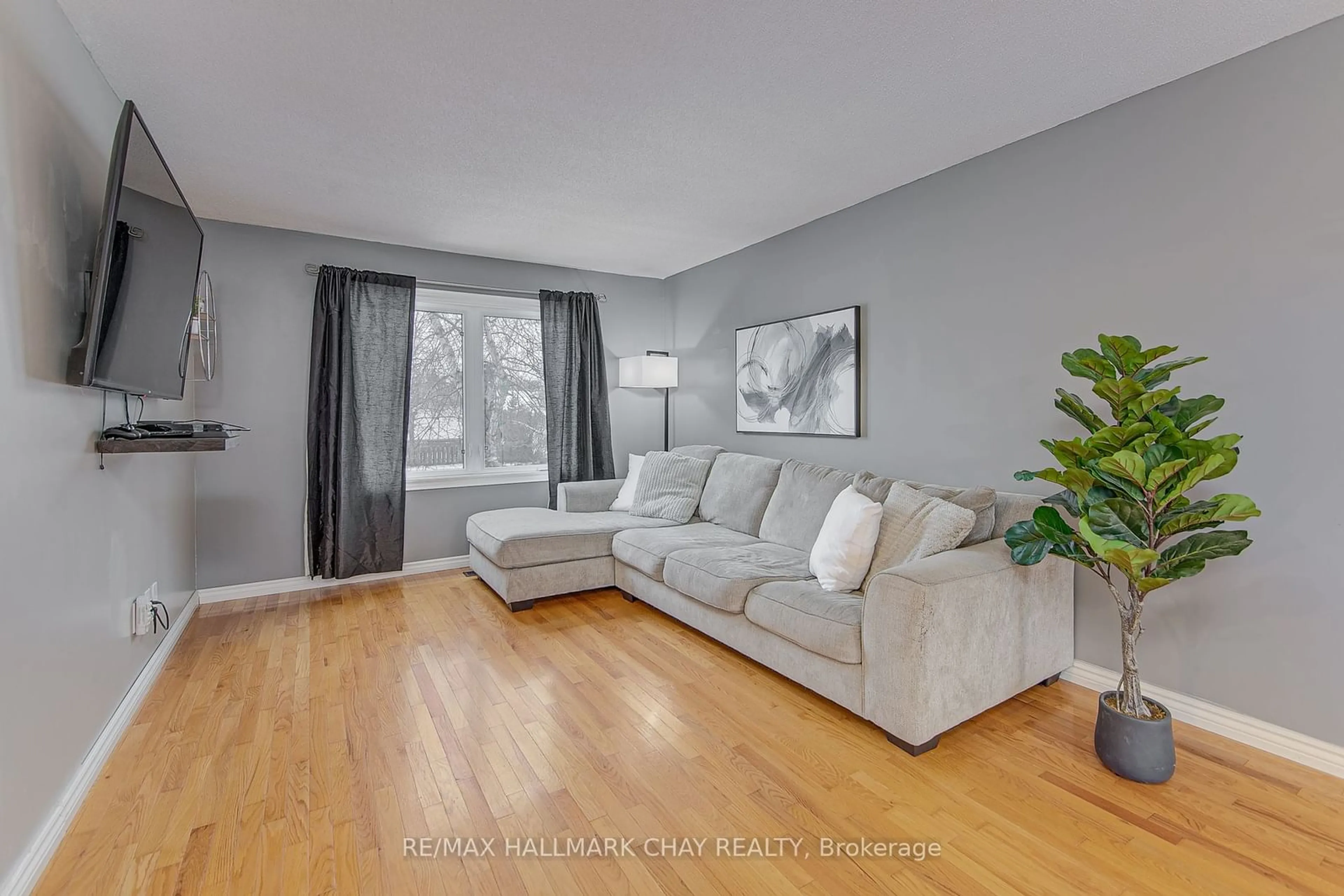 Living room with furniture, wood/laminate floor for 65 Sandy Lane, Essa Ontario L0M 1B3