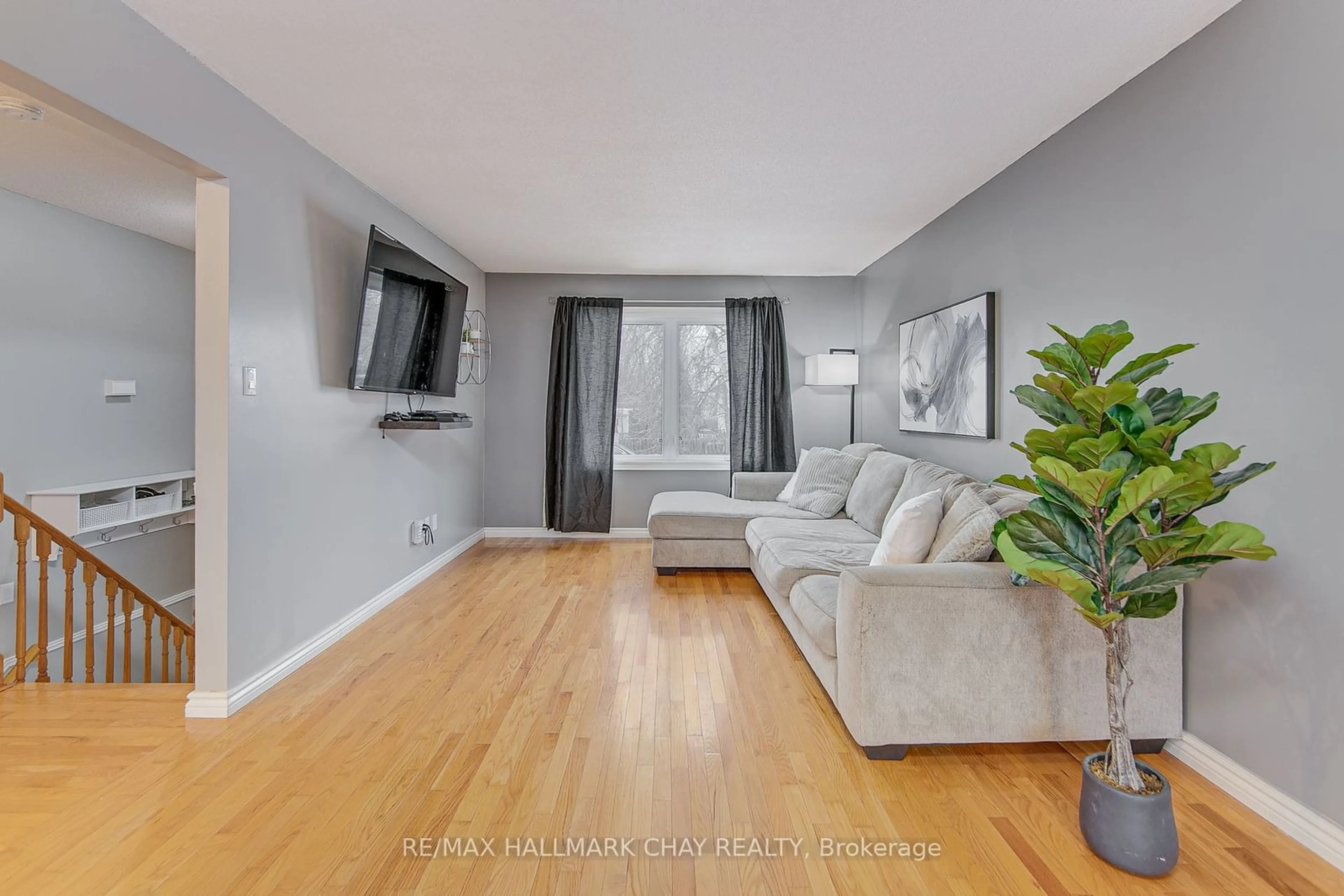 Living room with furniture, wood/laminate floor for 65 Sandy Lane, Essa Ontario L0M 1B3