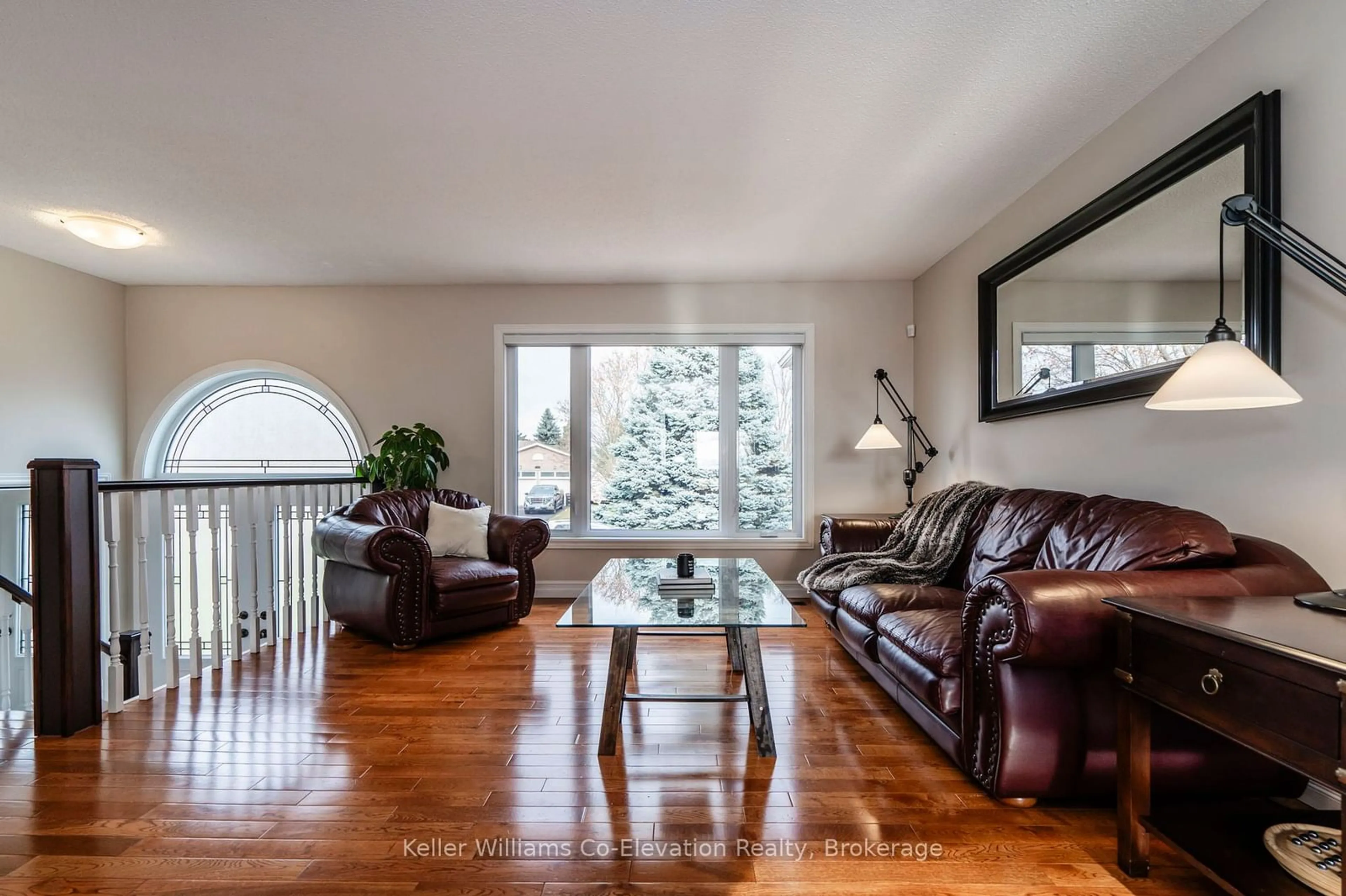 Living room with furniture, wood/laminate floor for 2145 Hughes Dr, Innisfil Ontario L0L 1R0