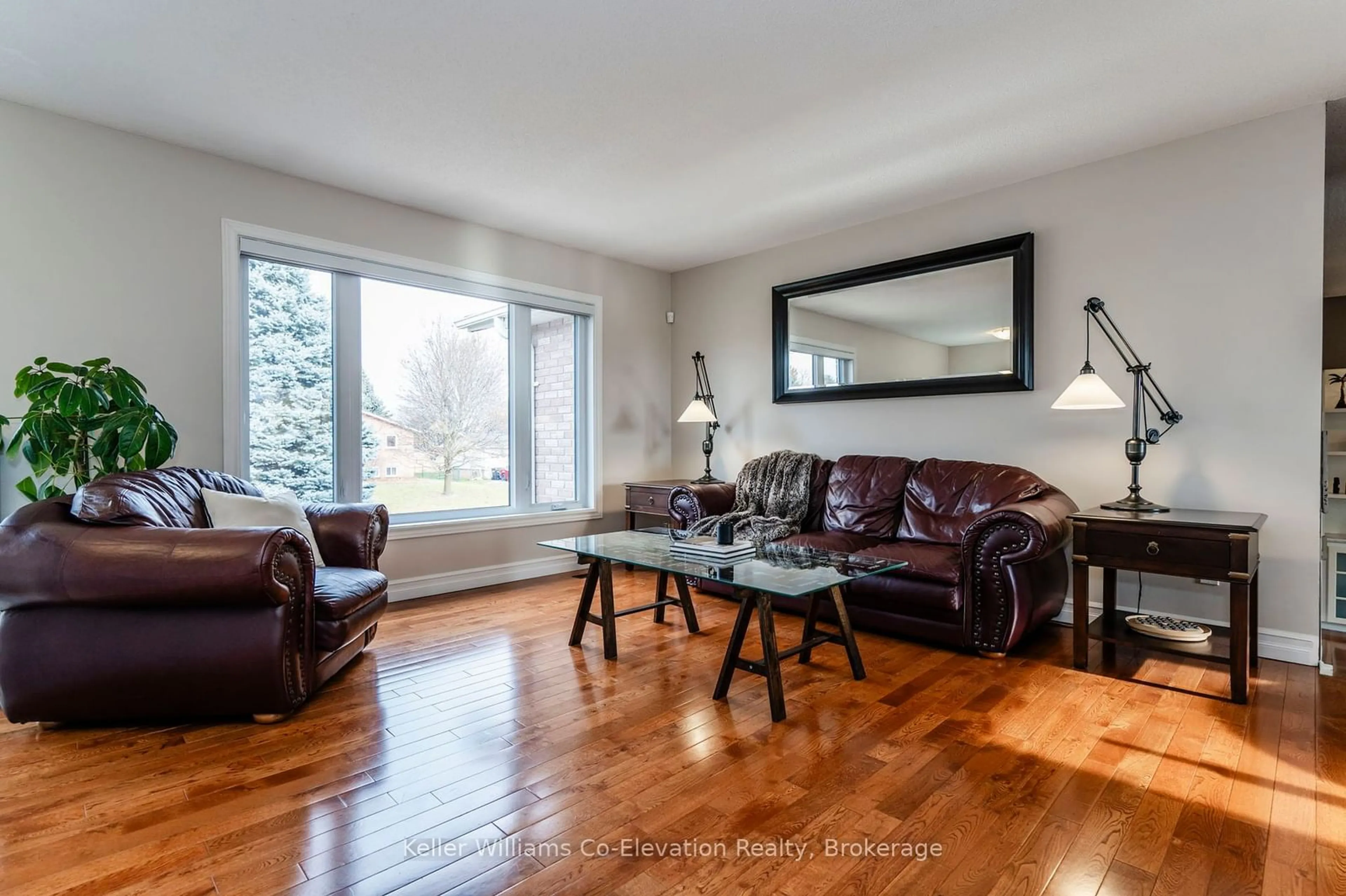 Living room with furniture, wood/laminate floor for 2145 Hughes Dr, Innisfil Ontario L0L 1R0