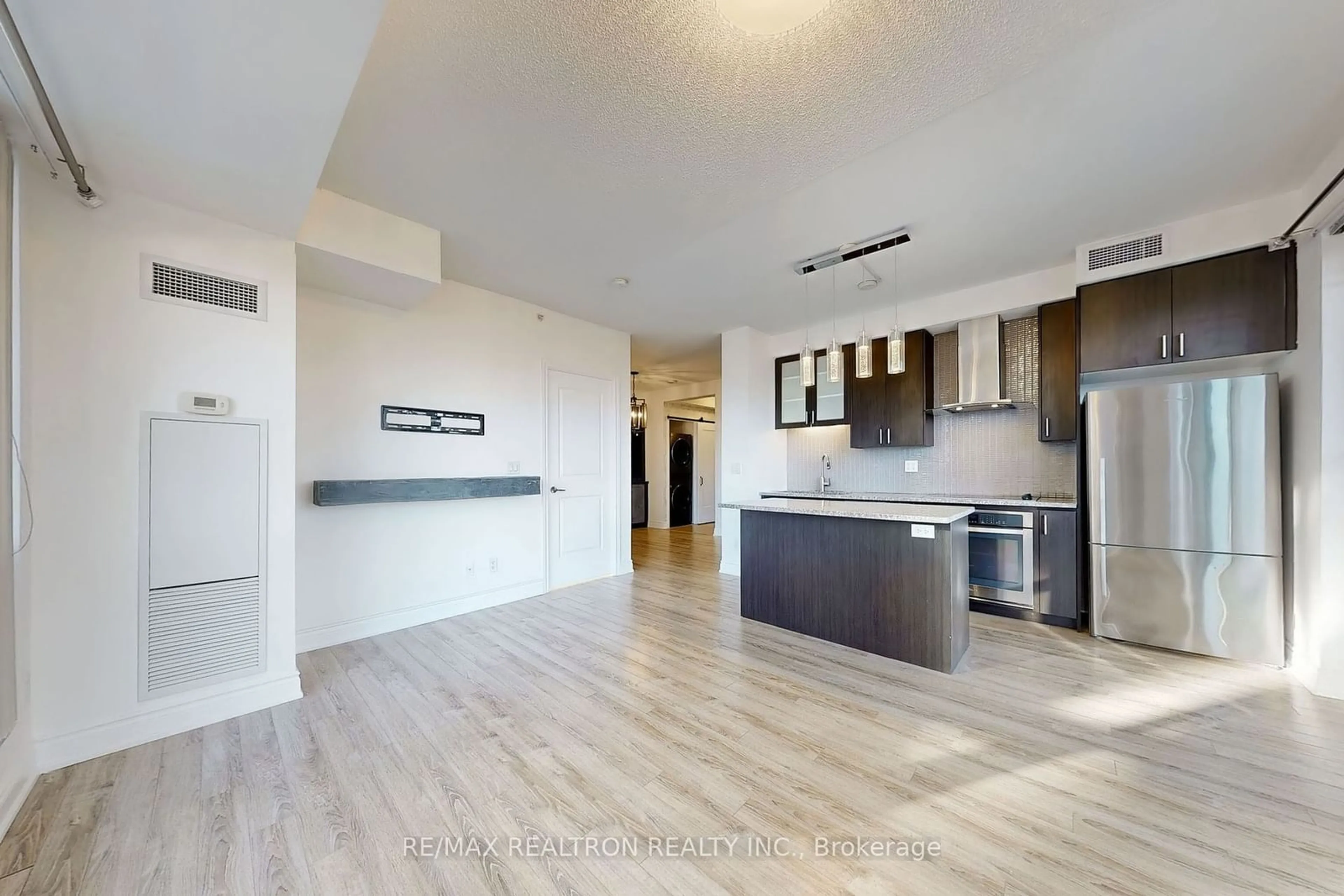 Open concept kitchen, wood/laminate floor for 9088 Yonge St #302A, Richmond Hill Ontario L4C 0Y6