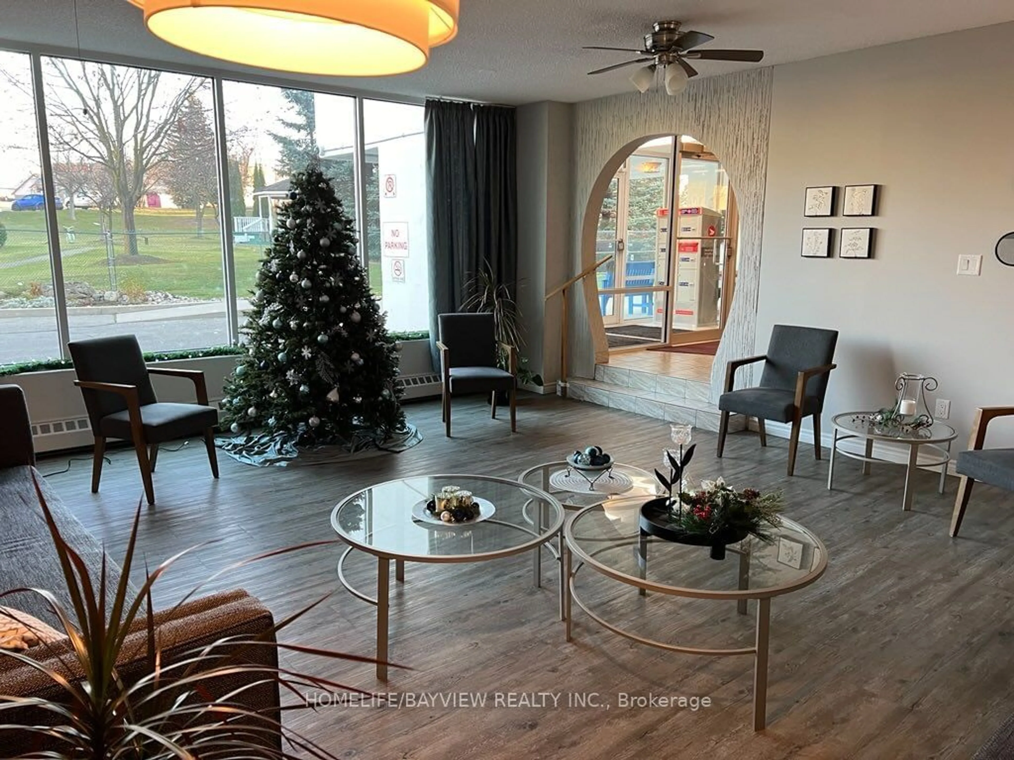 Living room with furniture, wood/laminate floor for 200 Holland Crt #303, Bradford West Gwillimbury Ontario L3Z 1R8