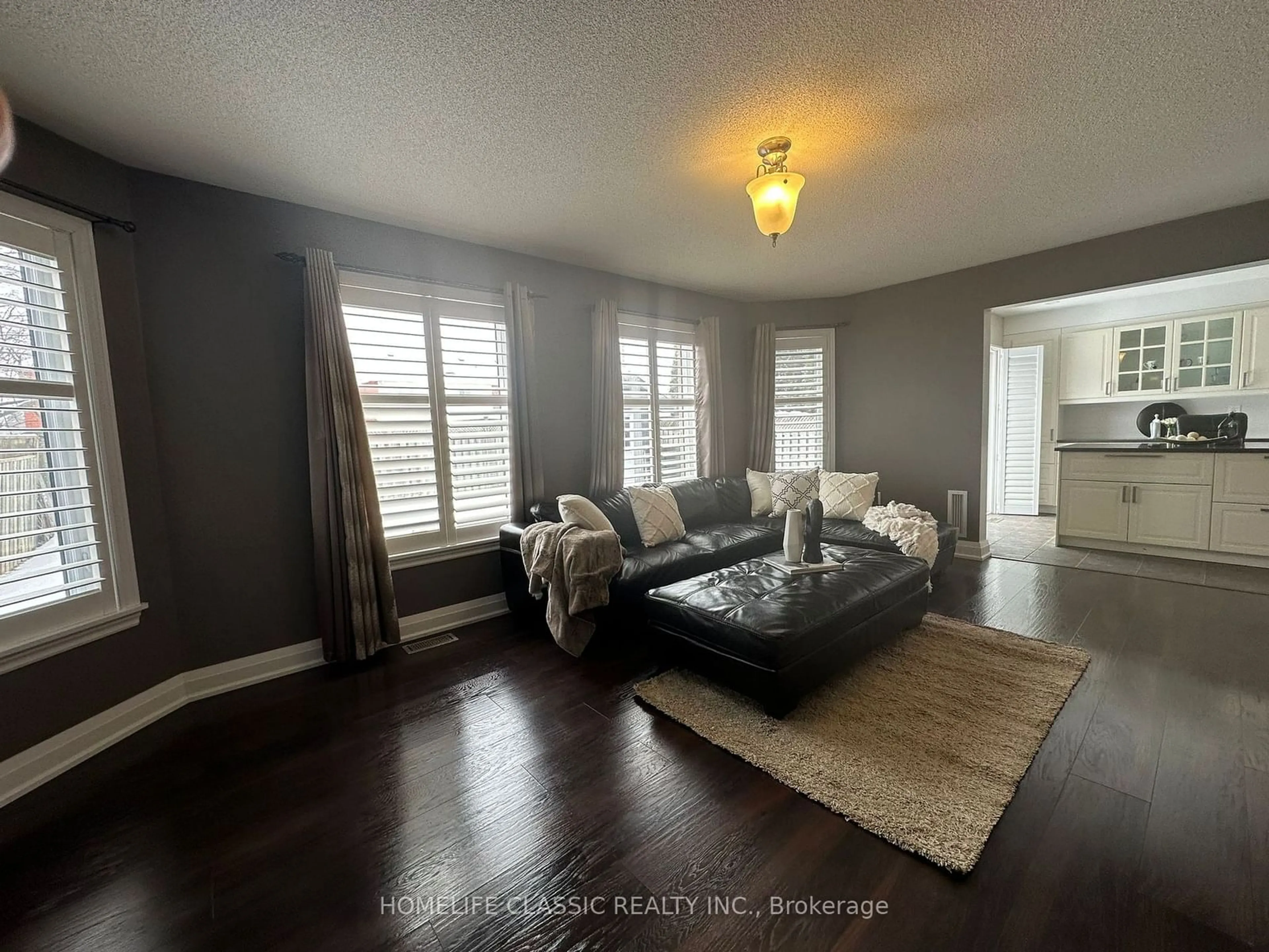 Living room with furniture, wood/laminate floor for 11 Smith St, New Tecumseth Ontario L9R 1Z8