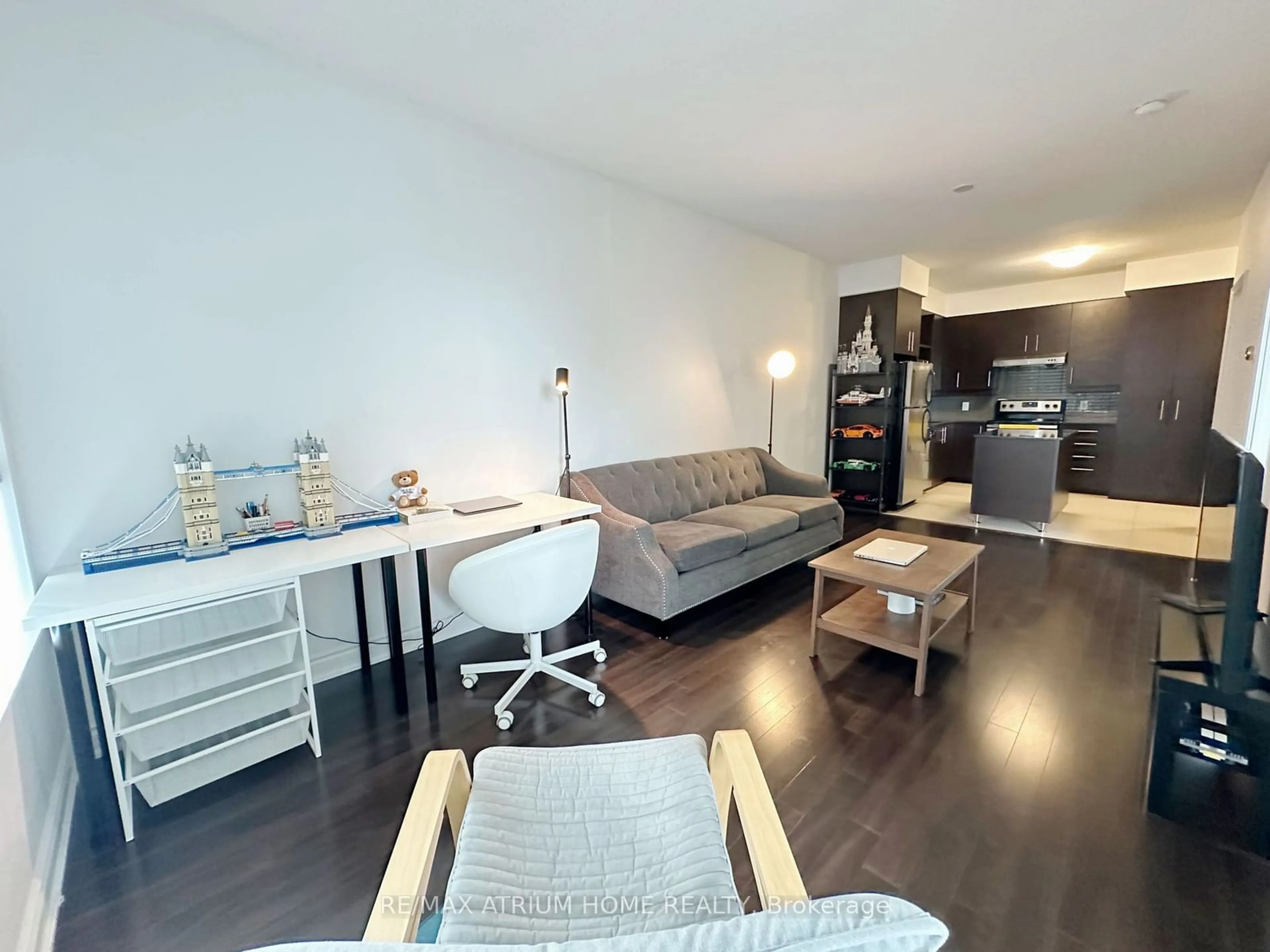 Living room with furniture, wood/laminate floor for 277 South Park Rd #316, Markham Ontario L3T 0B7