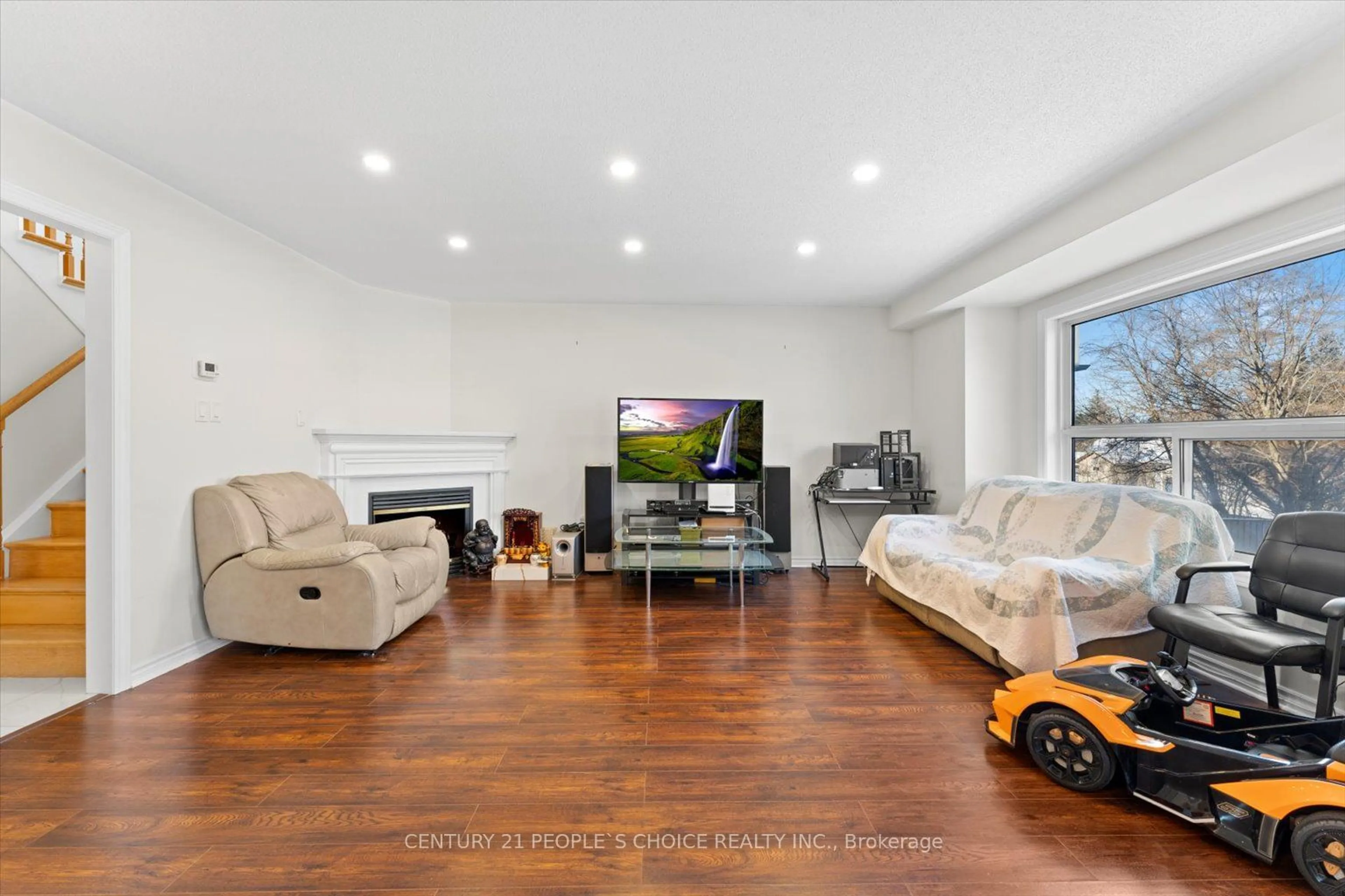 Living room with furniture, wood/laminate floor for 26 Rainbow Crt, Georgina Ontario L4P 3Z6