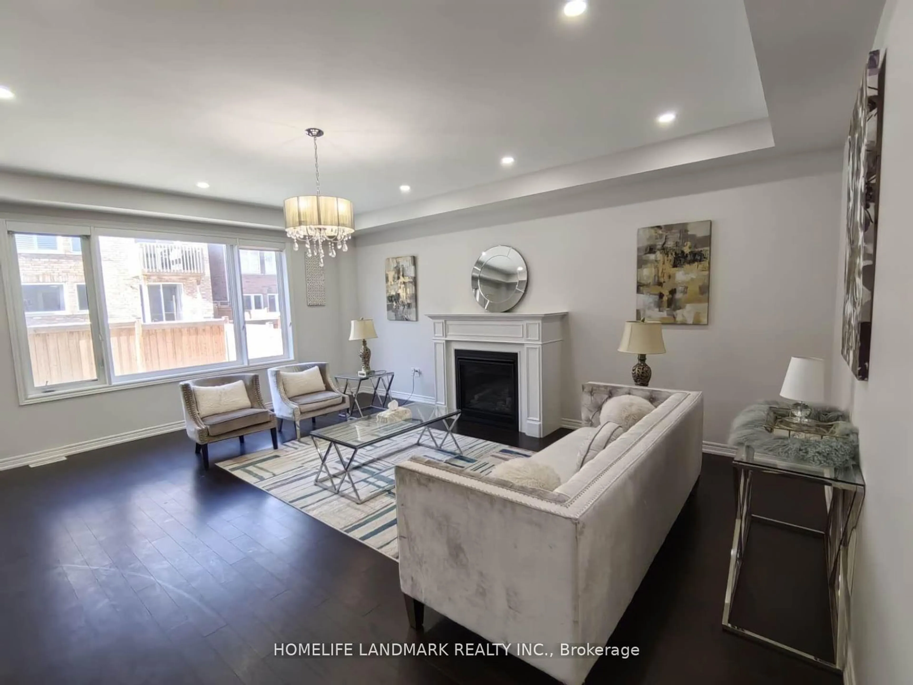 Living room with furniture, wood/laminate floor for 79 Forest Edge Cres, East Gwillimbury Ontario L9N 1R8