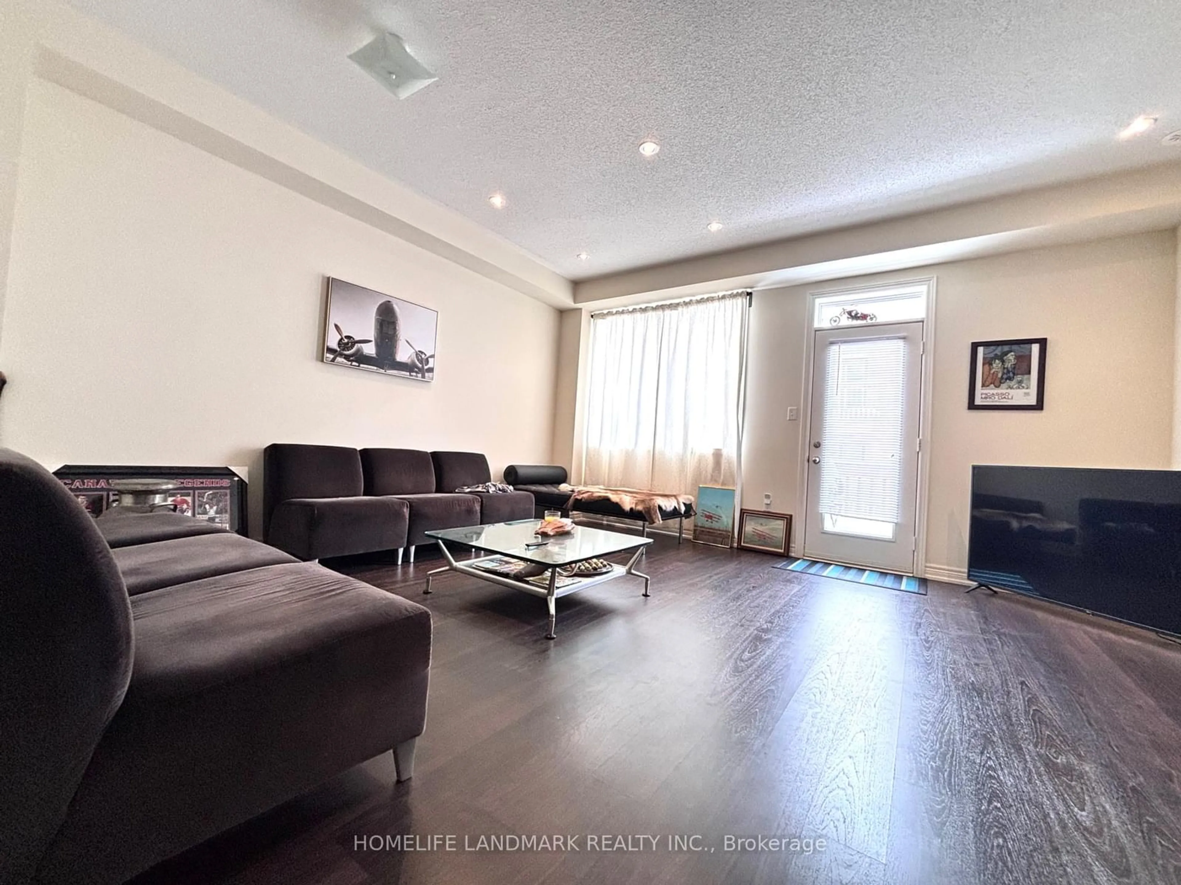 Living room with furniture, wood/laminate floor for 169 Roy Grove Way #149, Markham Ontario L6E 0T7