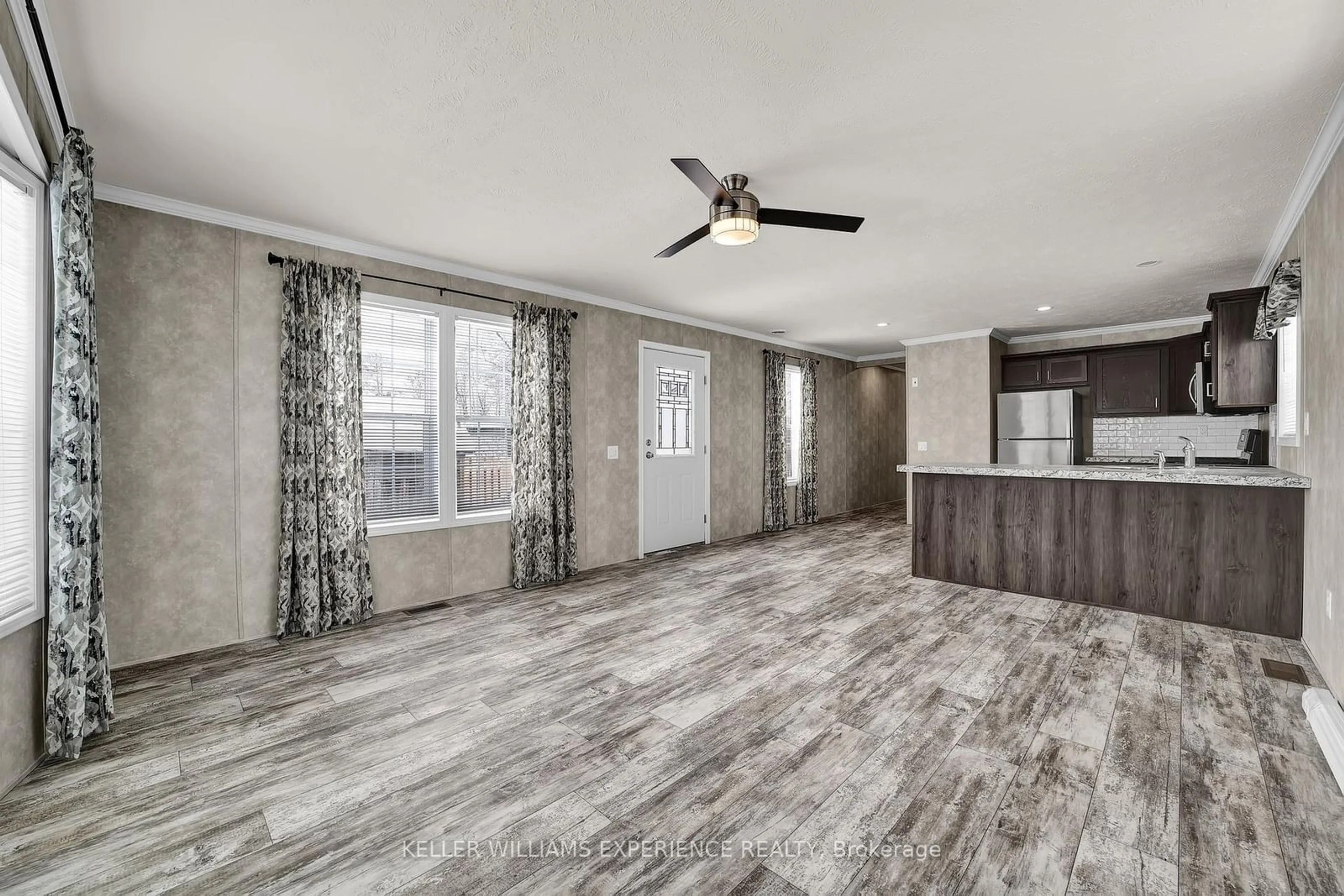 Open concept kitchen, wood/laminate floor for 40 Shamrock Cres, Essa Ontario L3W 0A5