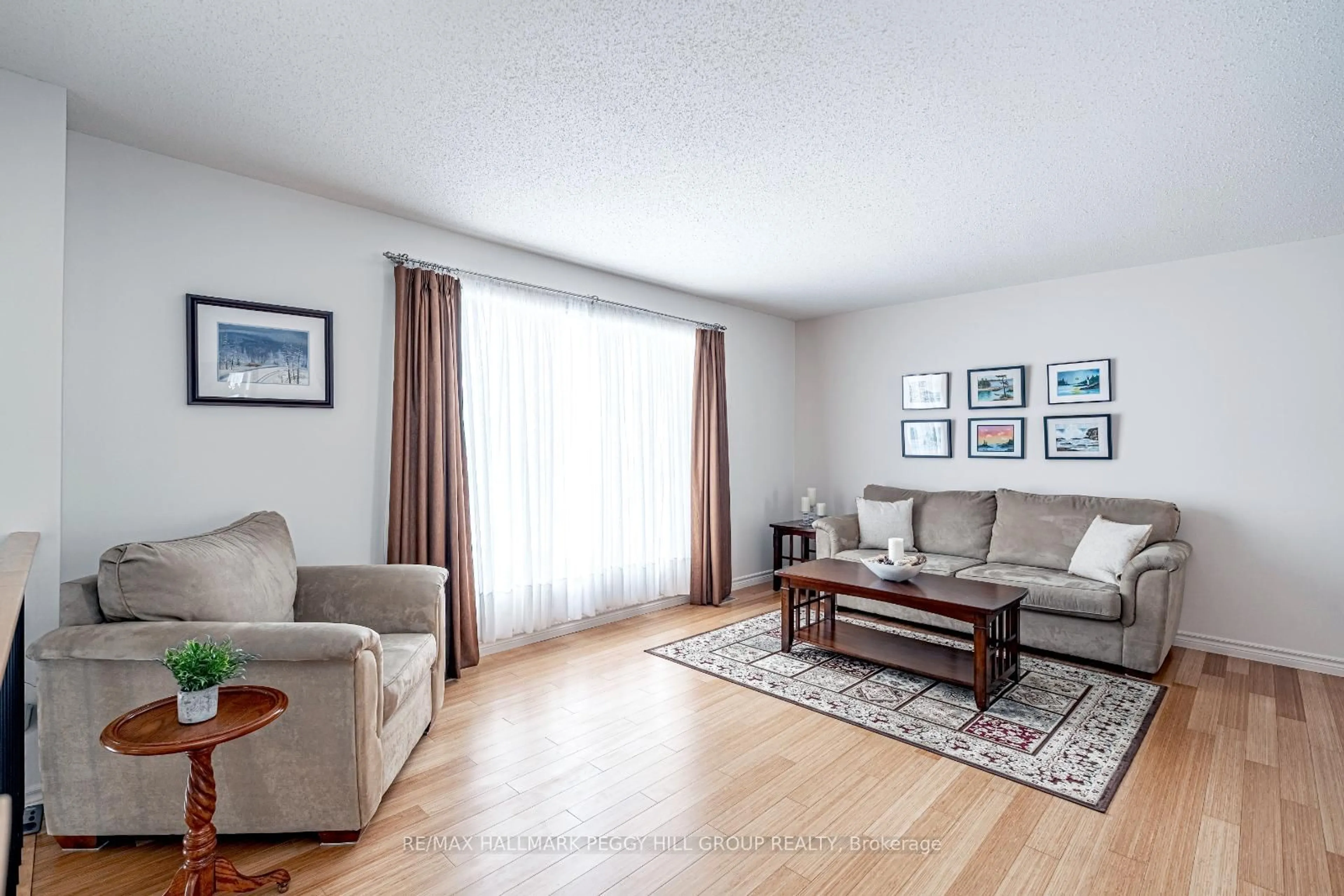 Living room with furniture, wood/laminate floor for 228 Thornton Ave, Essa Ontario L0L 2N0