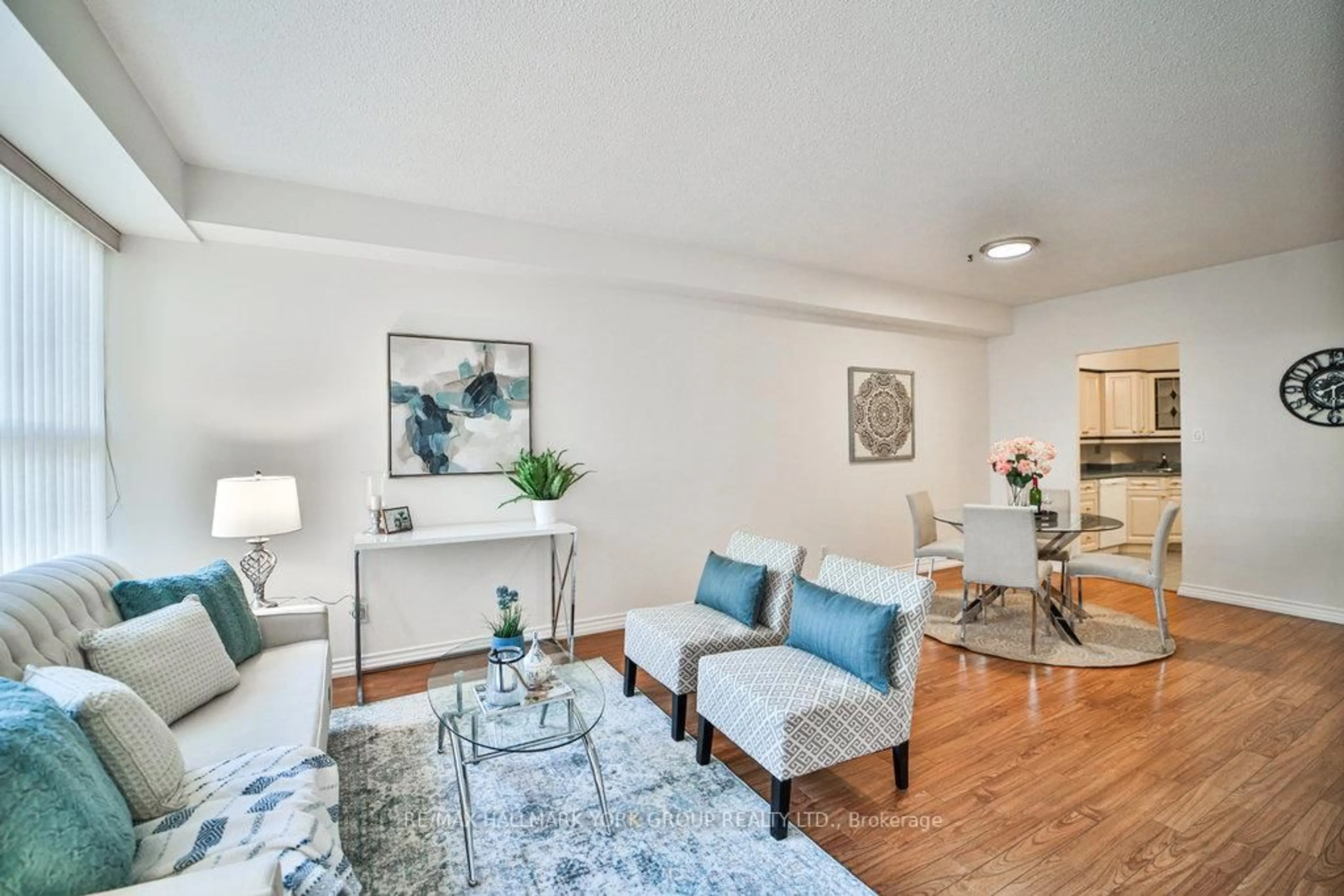 Living room with furniture, wood/laminate floor for 250 Davis Dr #105, Newmarket Ontario L3Y 7T7