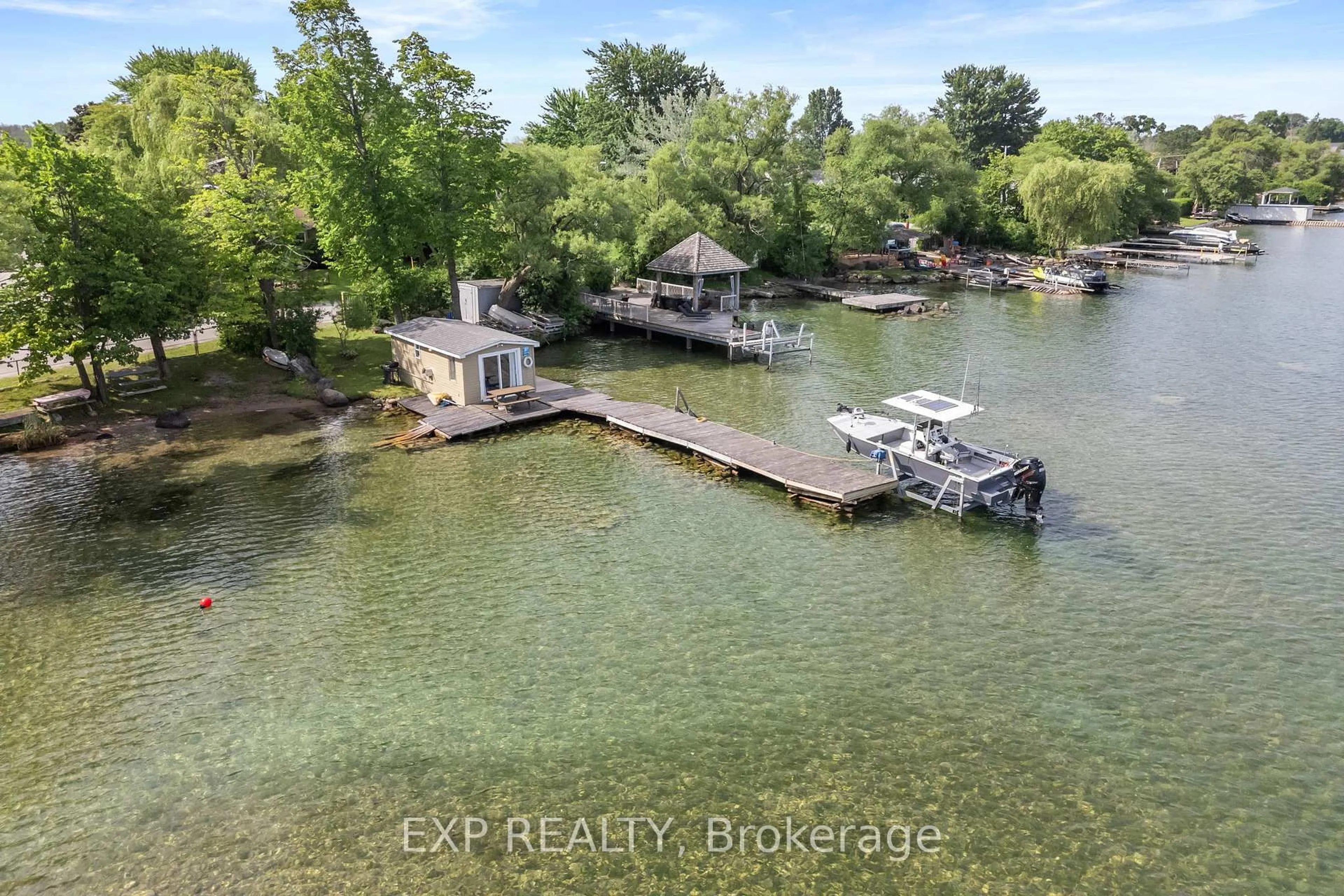 A pic from outside/outdoor area/front of a property/back of a property/a pic from drone, water/lake/river/ocean view for 21 Lake Dr, Georgina Ontario L4P 3E9