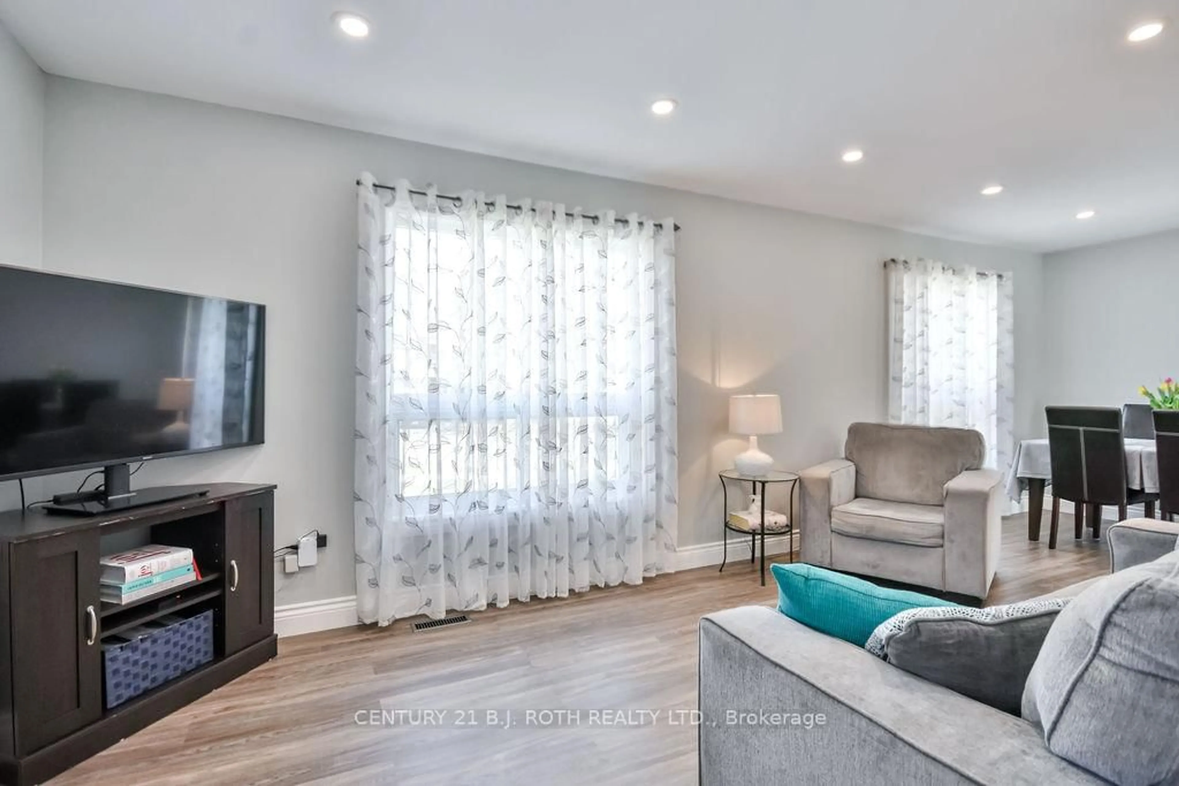 Living room with furniture, wood/laminate floor for 695 Candaras St, Innisfil Ontario L9S 2G9