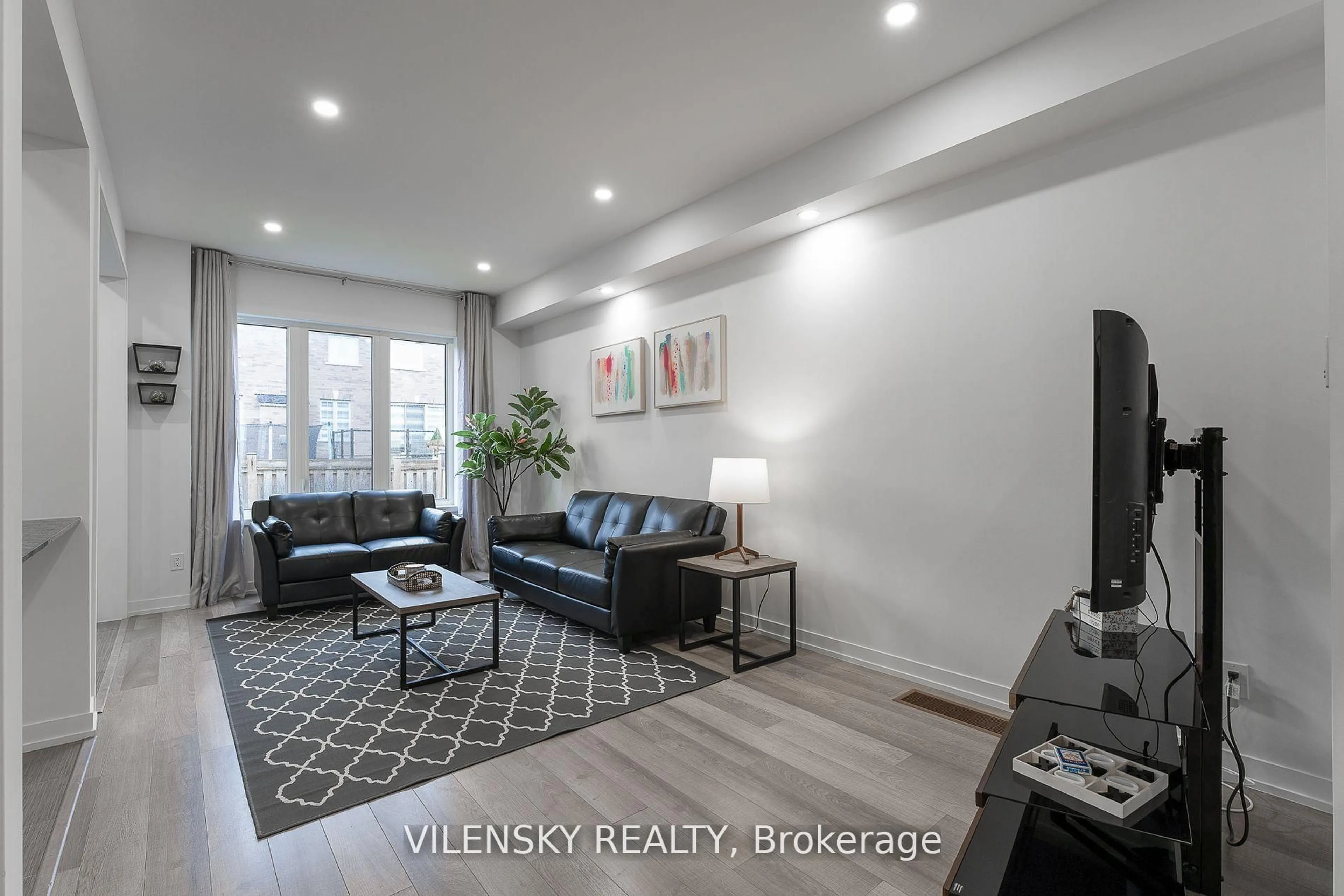Living room with furniture, wood/laminate floor for 126 Maguire Rd, Newmarket Ontario L3X 0M1