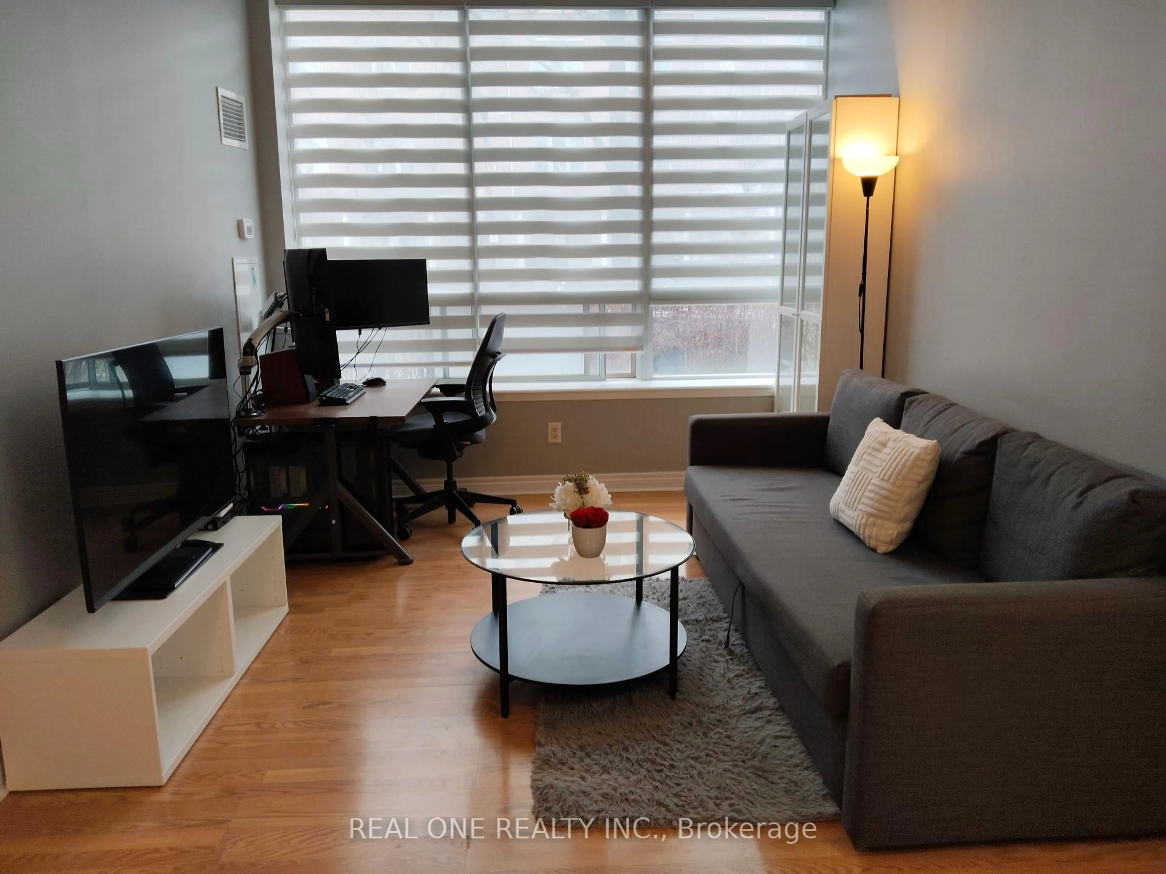 Living room with furniture, wood/laminate floor for 25 Times Ave #103, Markham Ontario L3T 7X5