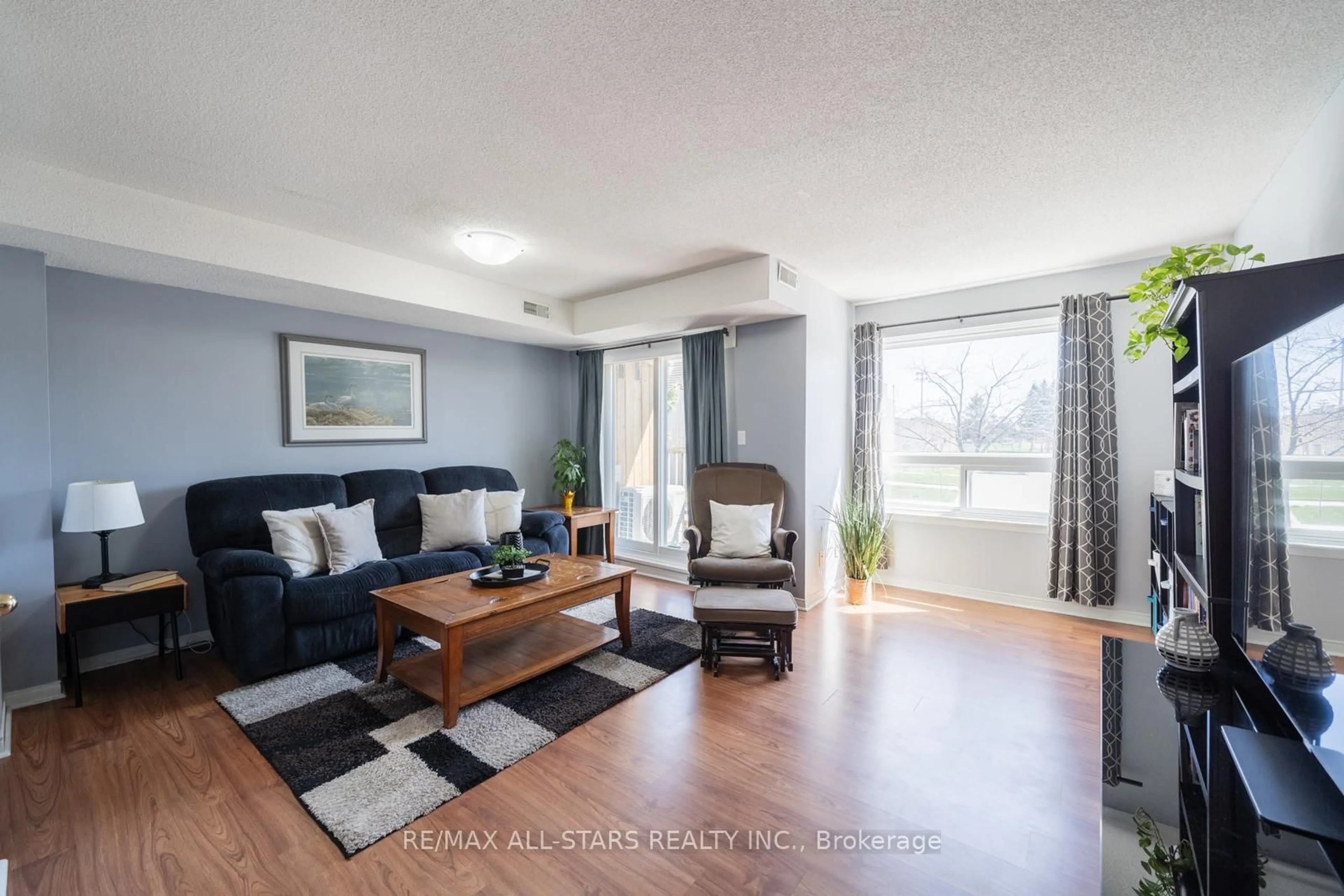 Living room with furniture, wood/laminate floor for 12421 Ninth Line #214, Whitchurch-Stouffville Ontario L4A 1J3