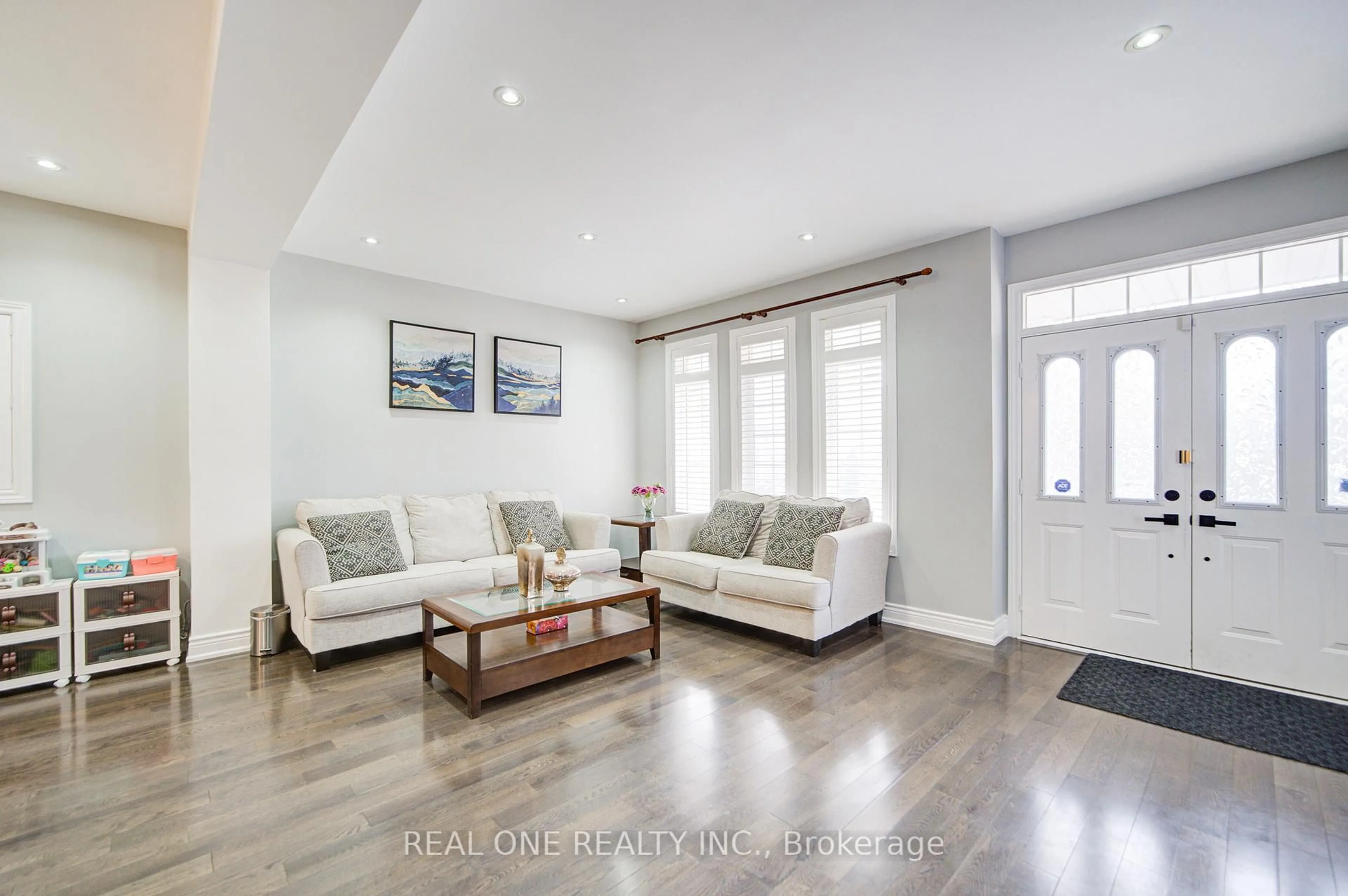 Living room with furniture, wood/laminate floor for 18 Sunburst Cres, Markham Ontario L6E 1R5