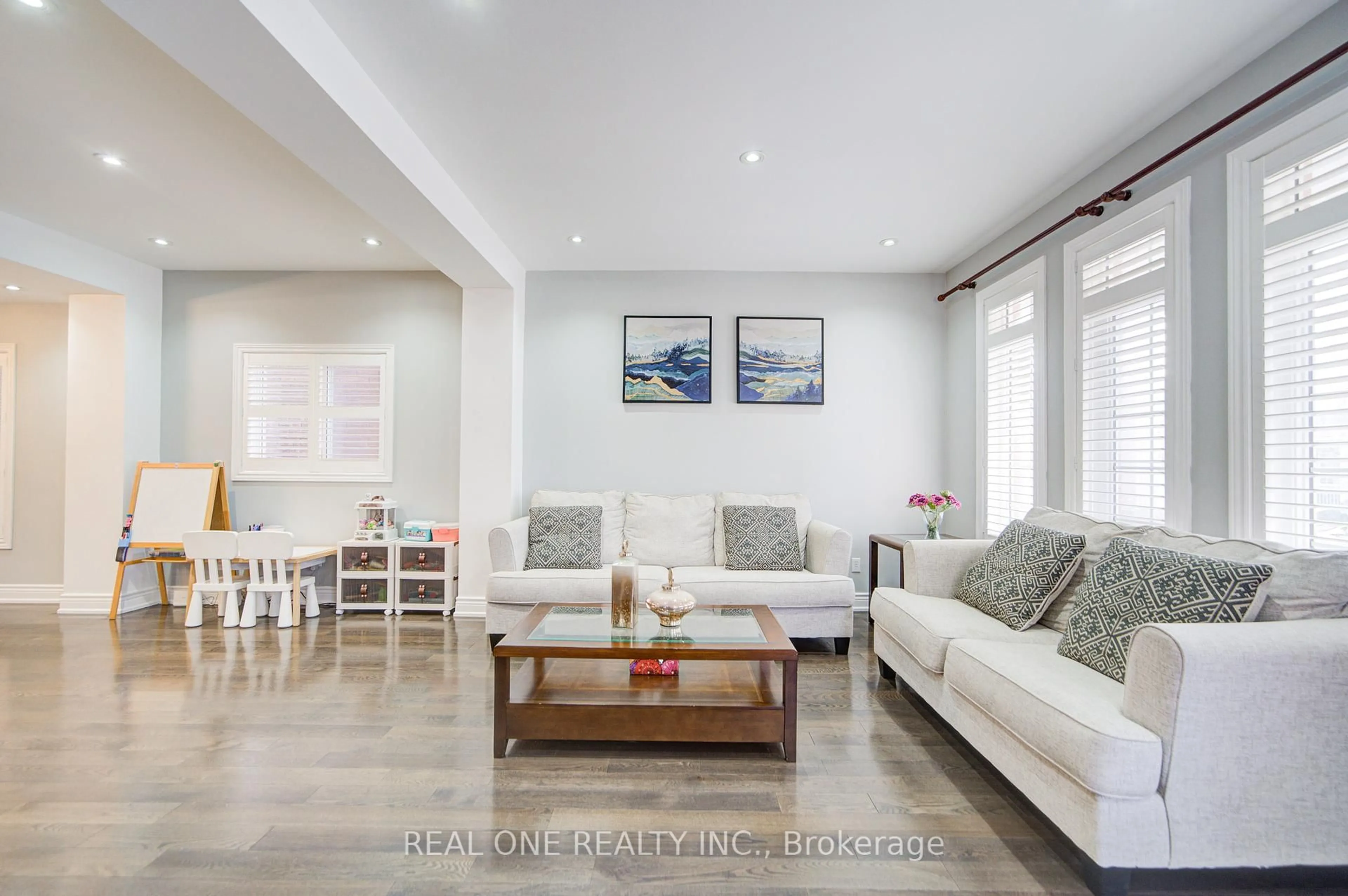 Living room with furniture, wood/laminate floor for 18 Sunburst Cres, Markham Ontario L6E 1R5